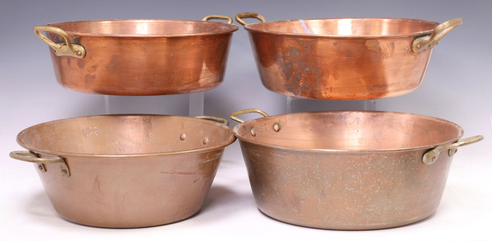 (4) FRENCH COPPER KITCHENWARE, LARGE SHALLOW HANDLED PANS: (lot of 4) Large French copper shallow pans, each with dual brass side handles, all unmarked, largest: approx 6"h, 18.5"w, 14.75"d, smallest: approx 5"h, 17.5"w, 14.75&qu