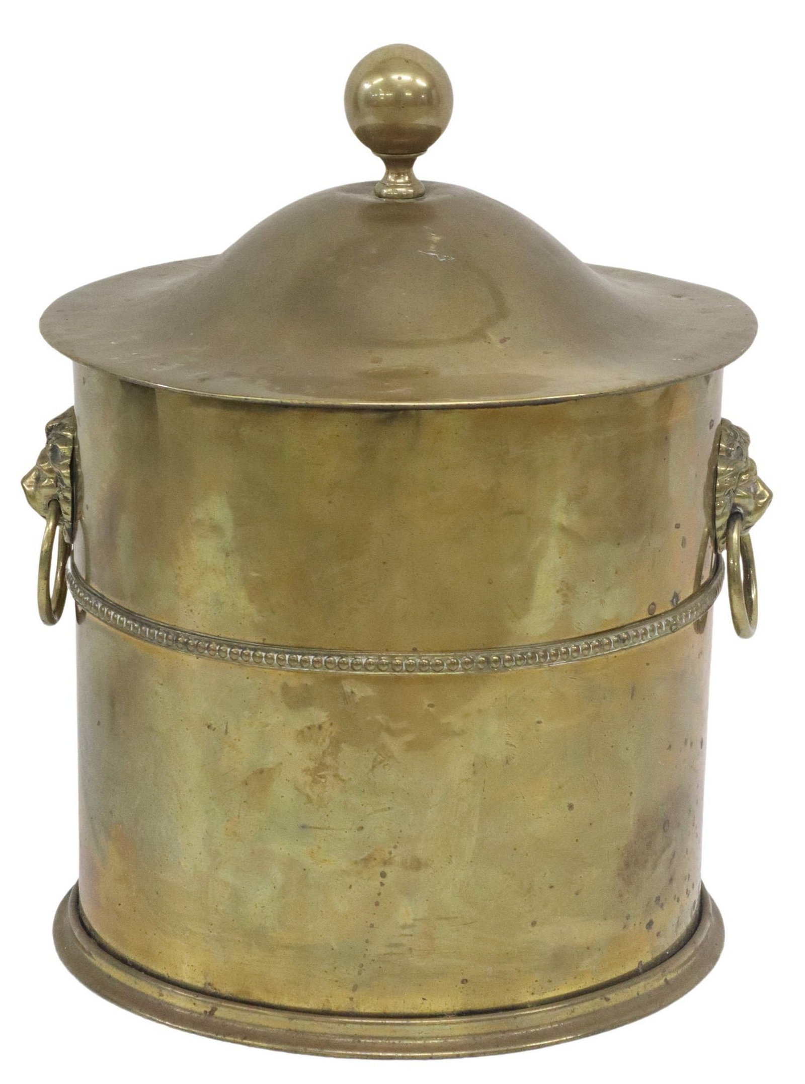 ENGLISH BRASS LION MASK COAL BIN: Brass coal bin, early 20th c., having cylindrical form, domed cover with sphere finial, the body with upper central register of studded detailing, and flanked by dual lion mask biting ring handles, th