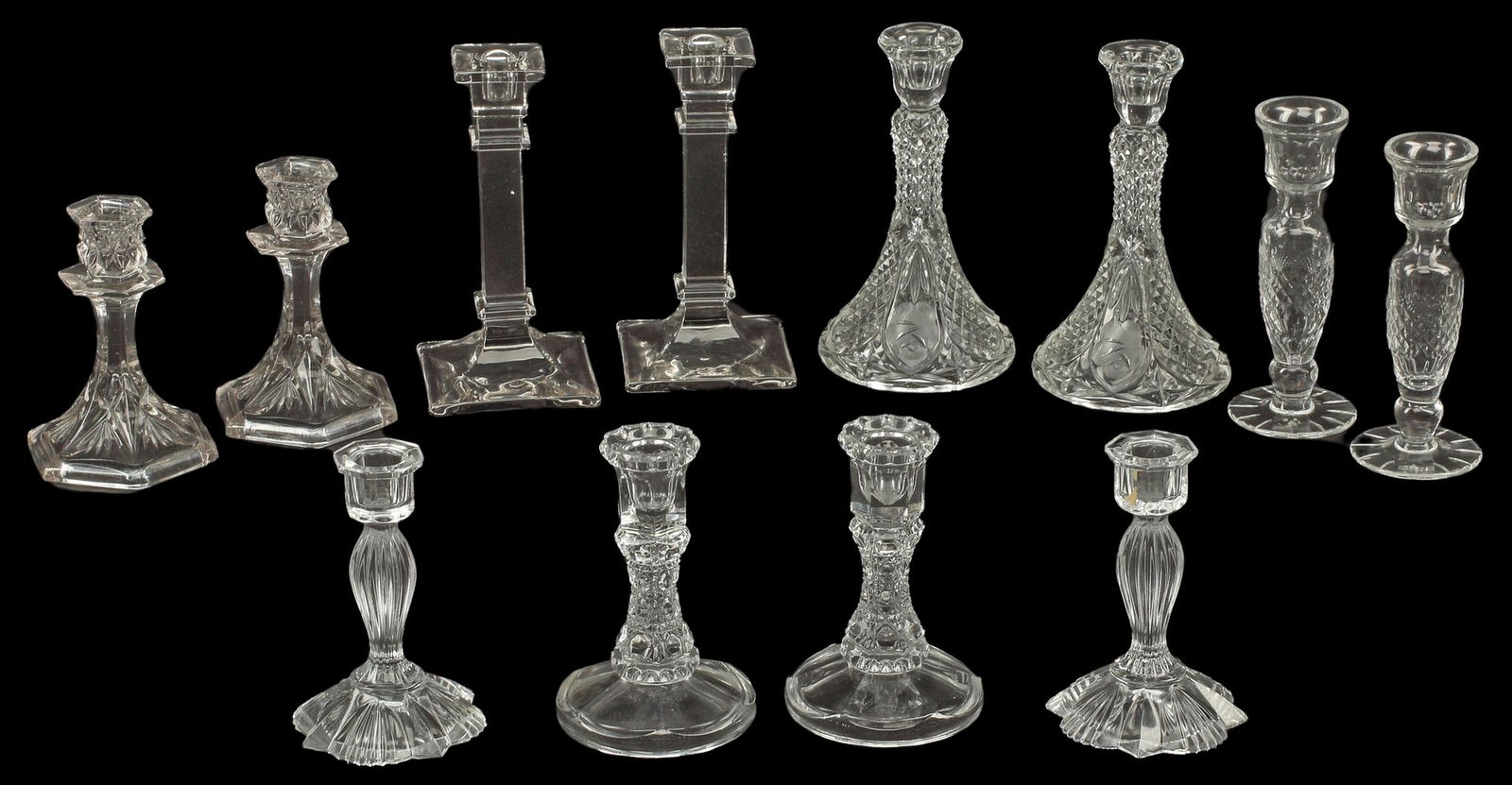 (12) PRESSED GLASS CANDLESTICKS: (lot of 12) Pressed glass candlesticks, comprising six pairs, largest: approx 8.25"h, 4.75"diam, 14lbs total