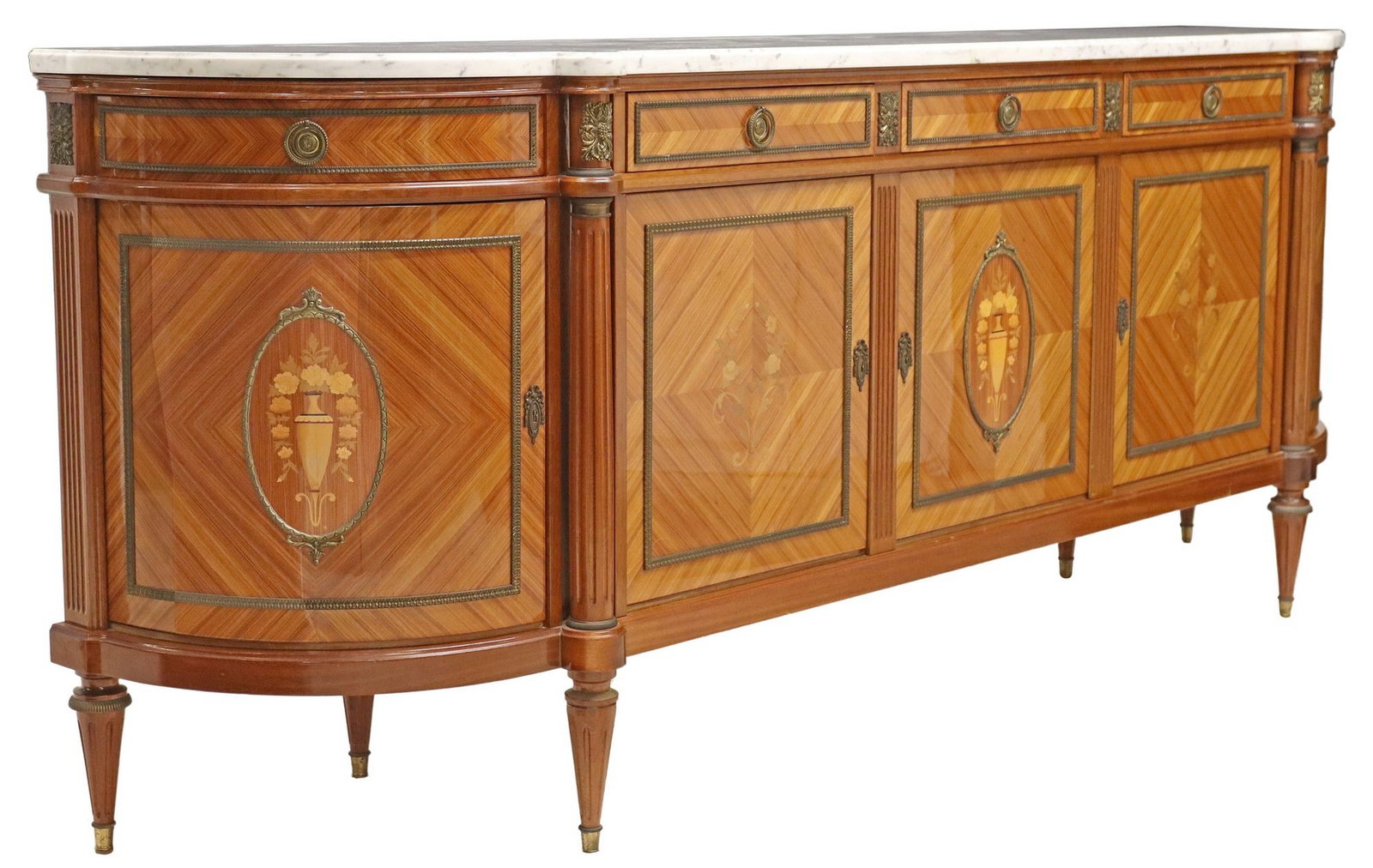FRENCH LOUIS XVI STYLE MARBLE-TOP MARQUETRY SIDEBOARD: French Louis XVI style matched veneer sideboard, 20th c., having shaped marble top, five drawers, above five cabinet doors, with inlaid urns and floral marquetry, revealing shelved interior, leftmost 