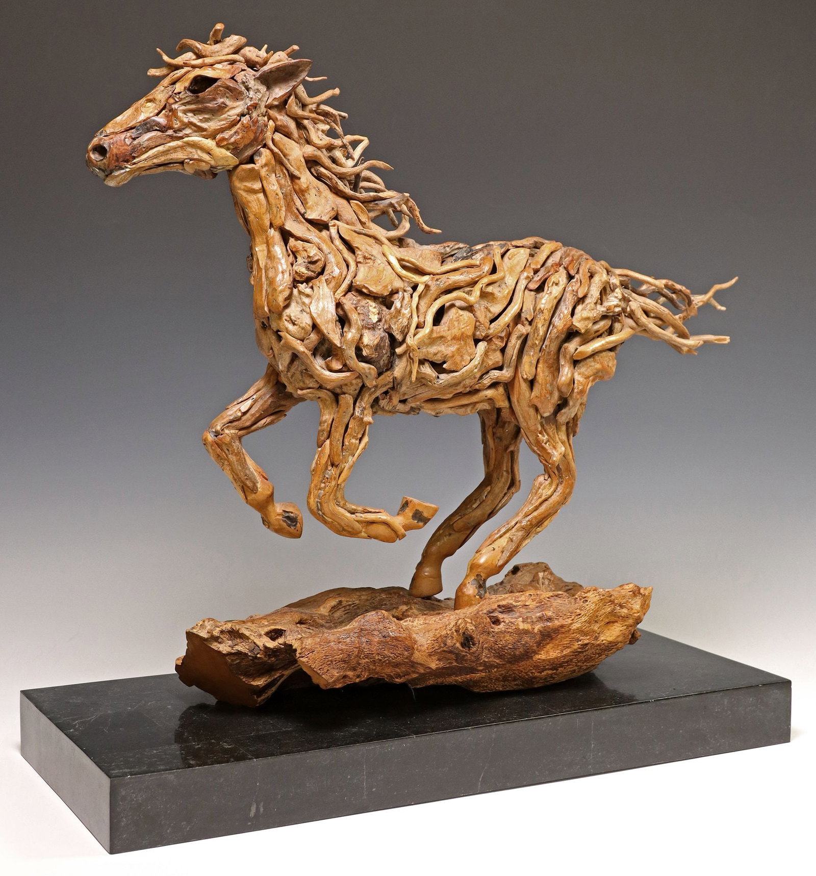 JAMES DORAN-WEBB (B.1967/68) DRIFTWOOD SCULPTURE, 'GALLOPING HORSE': Assembled and carved driftwood sculpture, "Galloping Horse," James Doran-Webb (United Kingdom/ Philippines, b.1967/68), numbered 41/ 50, rising on stone-tiled platform base, title plaque wit