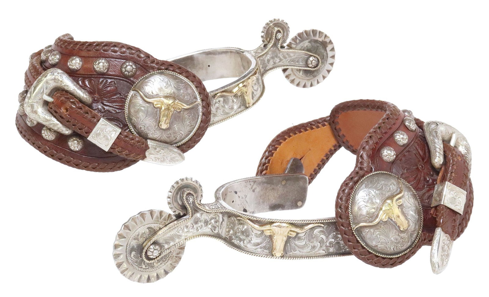(PAIR) EDWARD H. BOHLIN ENGRAVED SILVER LONGHORN PARADE SPURS: (pair) Western sterling silver parade spurs, Edward H. Bohlin, Hollywood, California, heel bands engraved in a foliate motif, 14kt yellow gold overlay longhorn head and diamond-form cartouch