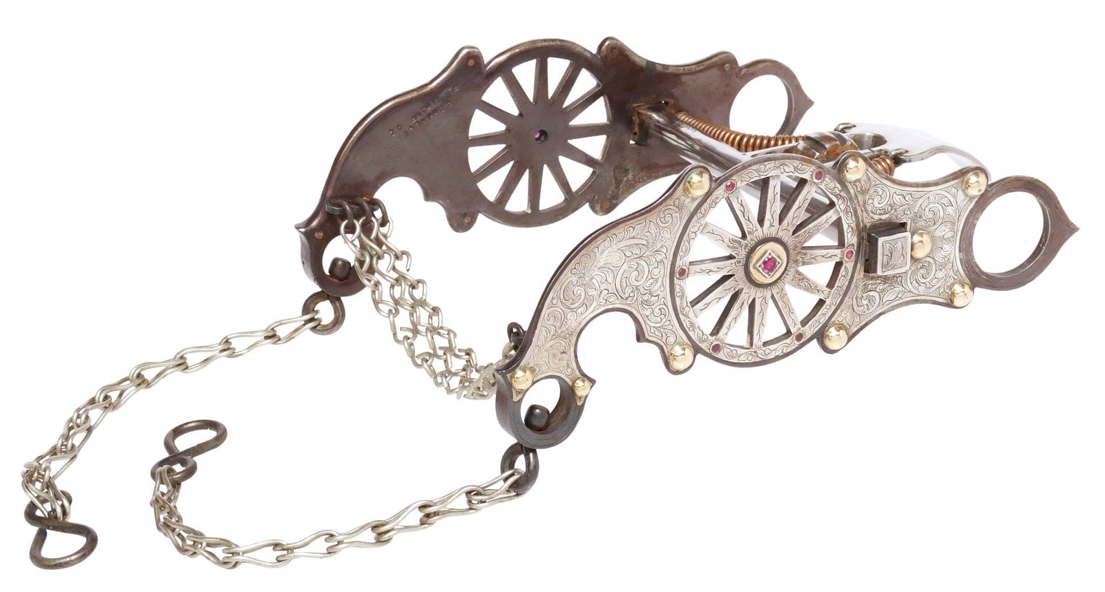 PERRY D. SHIRLEY (B.1949) FLAGSTAFF AZ SILVER-INLAID WAGON WHEEL SPADE BIT: Western silver-inlaid steel horse bit, marked P. Shirley, Flagstaff, AZ (Perry D. Shirley, Texas, Arizona, b.1949), engraved foliate motif, pierced wagon wheel accented with rubies, approx 3 7/8"