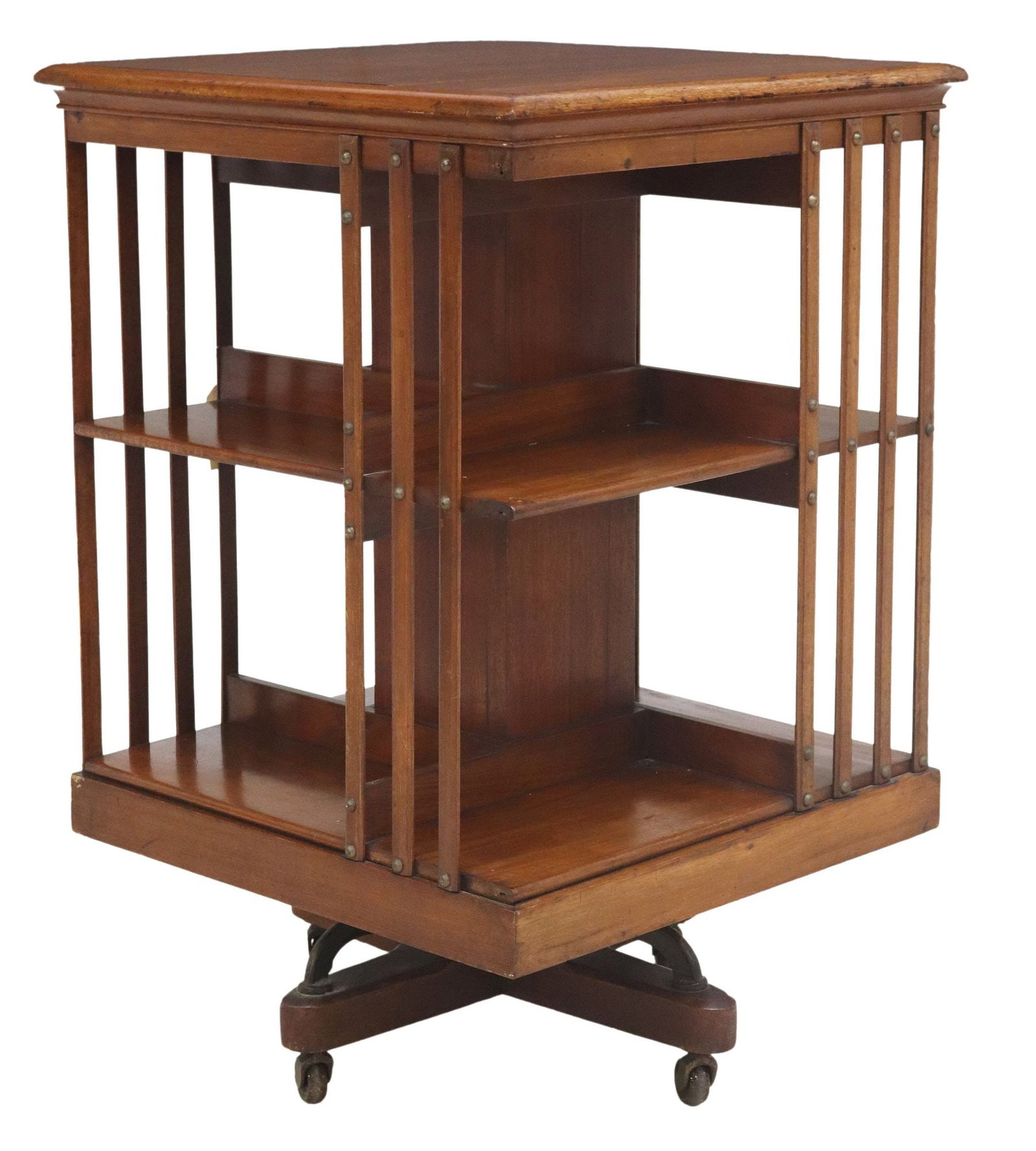 ENGLISH MAHOGANY ROTATING BOOKCASE LIBRARY STAND: English mahogany rotating bookcase/ library stand, early 20th c., having square top over two tiers with slatted sides, rising on casters, top intact with fill restoration, approx 36 1/8"h, 2