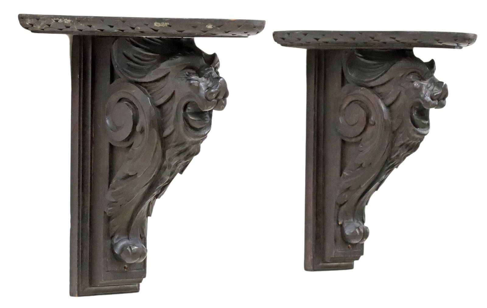 (2) ITALIAN RENAISSANCE REVIVAL EBONIZED CARVED LION WALL BRACKETS: (pair) Italian Renaissance Revival ebonized wall brackets, late 19th c., each having shaped top with molded trim, rising on carved support modeled as a roaring lion, approx 13"h, 11"w, 9&quo