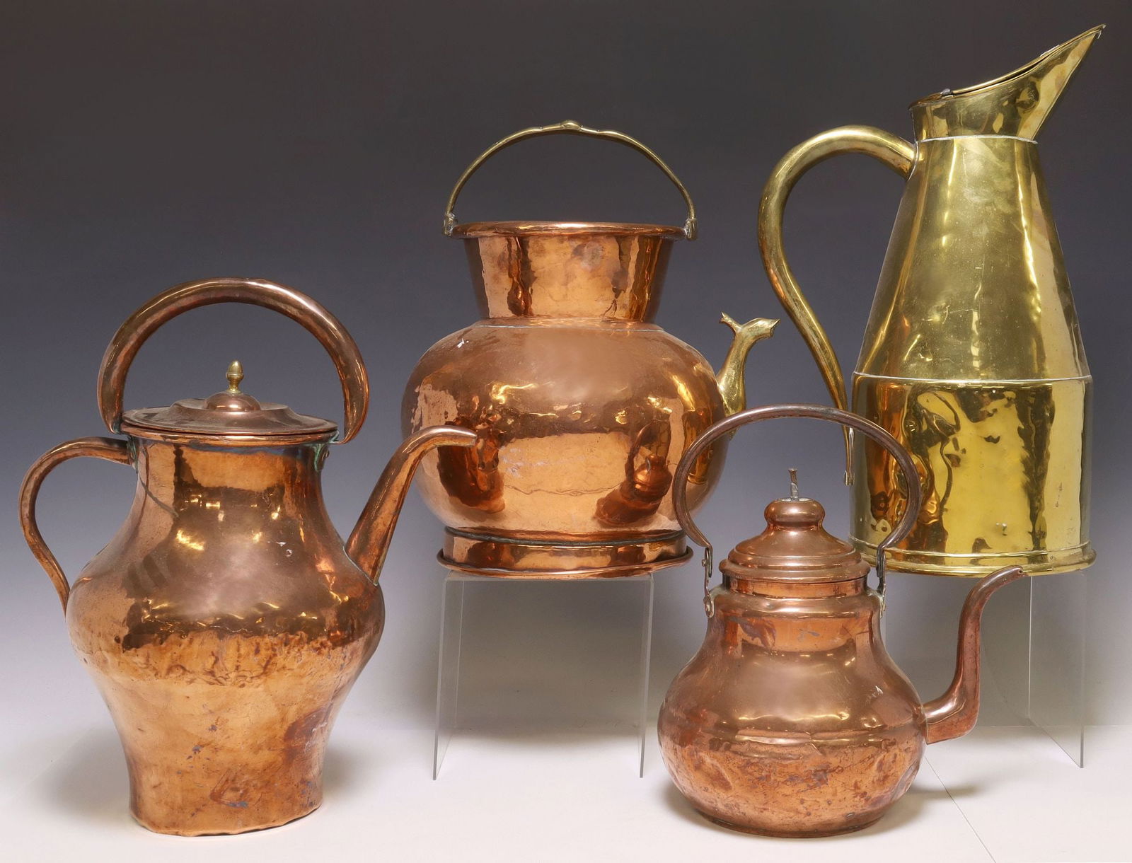 (4) FRENCH COPPER & BRASS HOT WATER KETTLES & PITCHERS: (lot of 4) French copper and brass vessels, late 19th/ early 20th c., including: (1) brass pitcher, hinged cover, side handle; (1) large hammered copper kettle, fixed brass handle and peacock-form spo