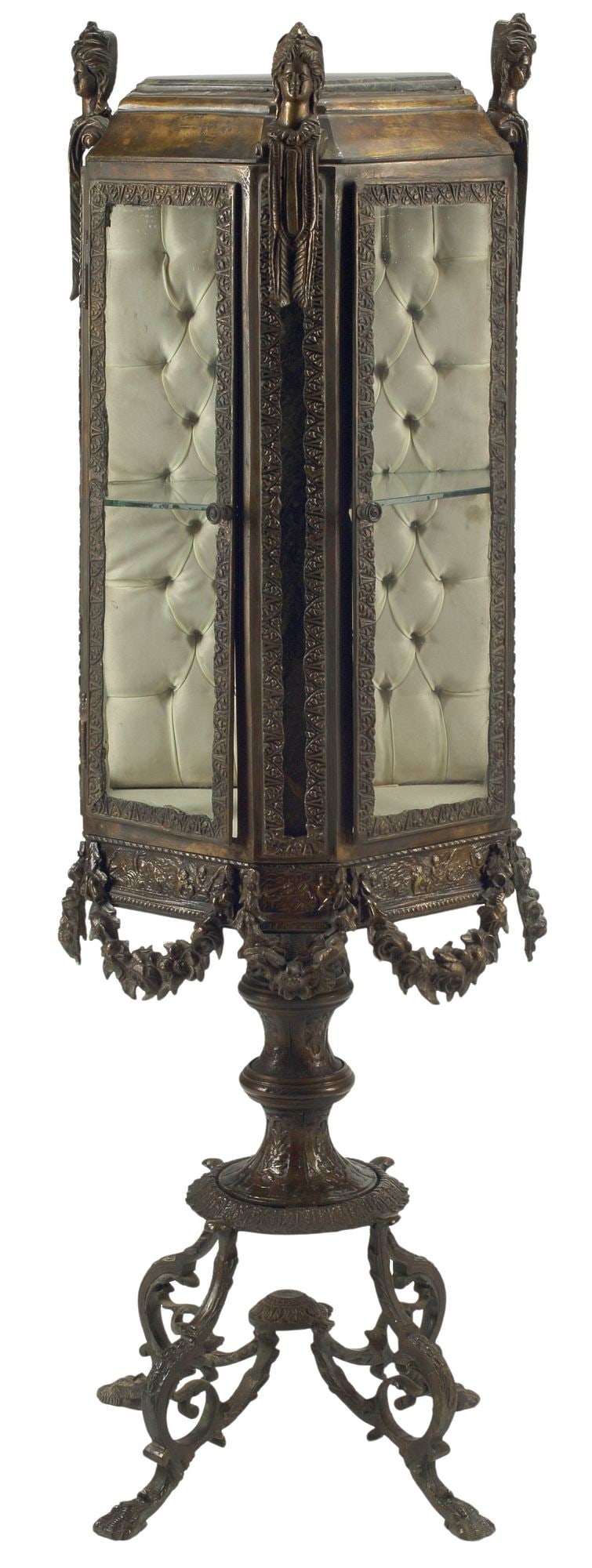 LOUIS XV STYLE PATINATED BRONZE PENTAGONAL GLAZED VITRINE CABINET: Louis XV style patinated bronze pentagonal vitrine/ display cabinet, having marble-top, molded case with protruding figural masks and draped floral swag, fitted with dual glazed cabinet doors, reveali