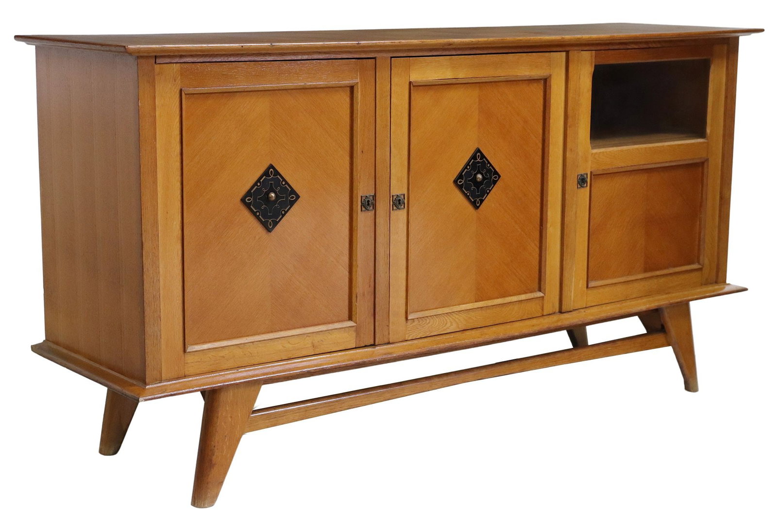 FRENCH MID-CENTURY MODERN OAK SIDEBOARD WITH BAR CABINET: French mid-century modern oak sideboard, c.1950s, square parquetry top, three doors, (one) with beveled glass pane, enclosing interior shelves and bottle holder, on tapering angled legs, approx 40&quo