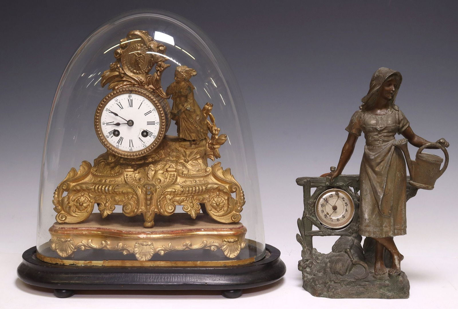 (2) FRENCH GILT METAL & SPELTER FIGURAL MANTEL CLOCKS, 1 IN GLASS CLOCHE: (lot of 2) French mantel clocks, late 19th/ early 20th c., including: (1) gilt metal clock, with figural topper beside white porcelain dial, with Roman numeral hour markers, unmarked time-and-str