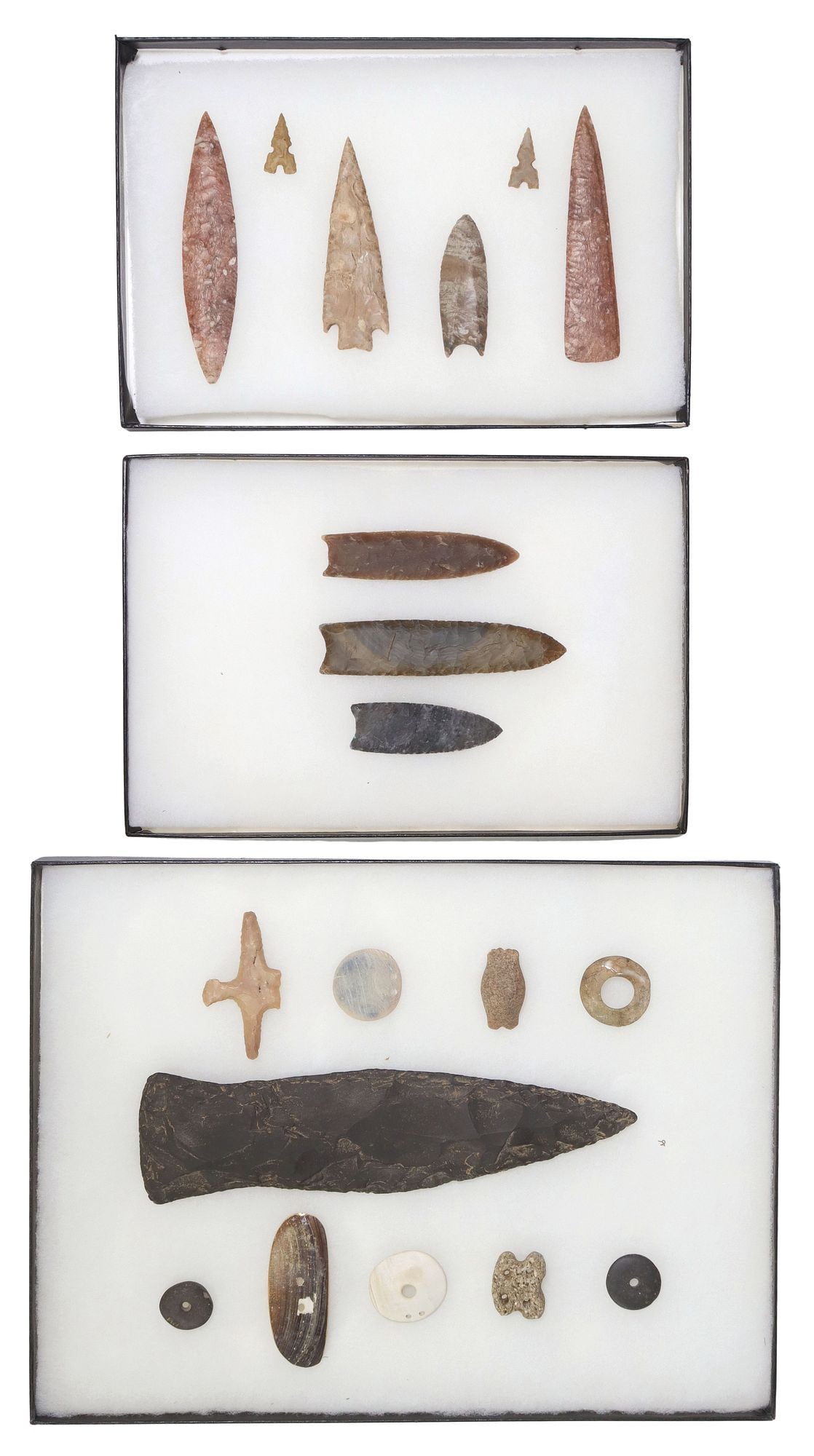 (19) STONE ARROWHEADS, SPEAR POINTS, BEADS & TOOLS IN RIKER BOXES: (lot of 19) Stone arrowheads, spear points, ornaments, and tools, housed in three Riker boxes, largest point: approx 10.75"l, 2.75"w, largest box: approx 1"h, 16.5"w, 12.5&quo