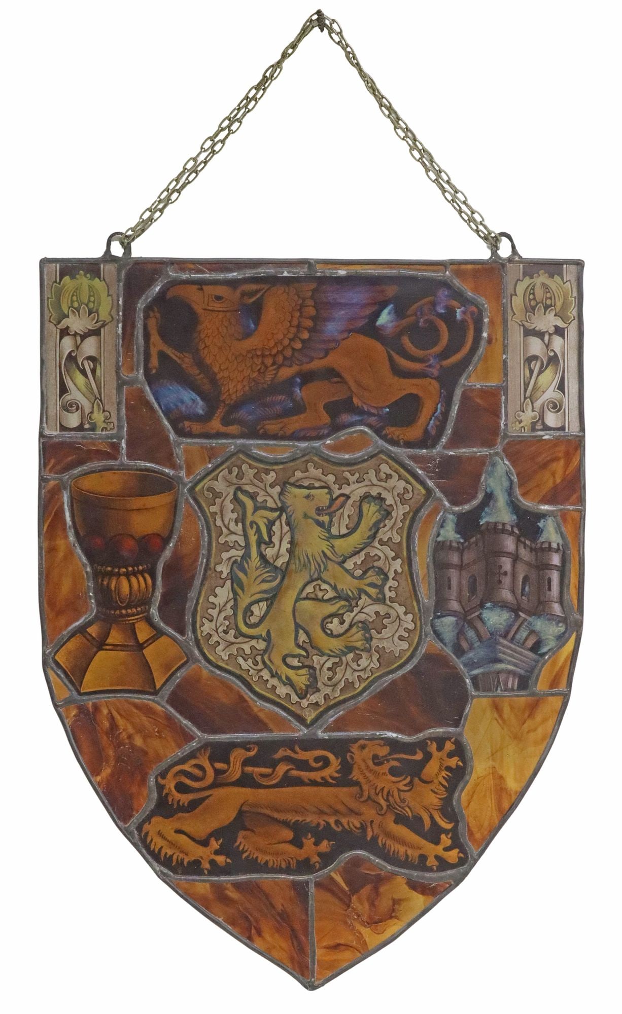 LARGE ENGLISH STAINED & LEADED REVERSE-PAINTED GLASS ARMORIAL PANEL: English stained and leaded glass heraldic panel, 19th c., shield-form frame with reverse-painted griffin above two lion rampant, flanked by architectural castle tower and goblet, some panels initialed