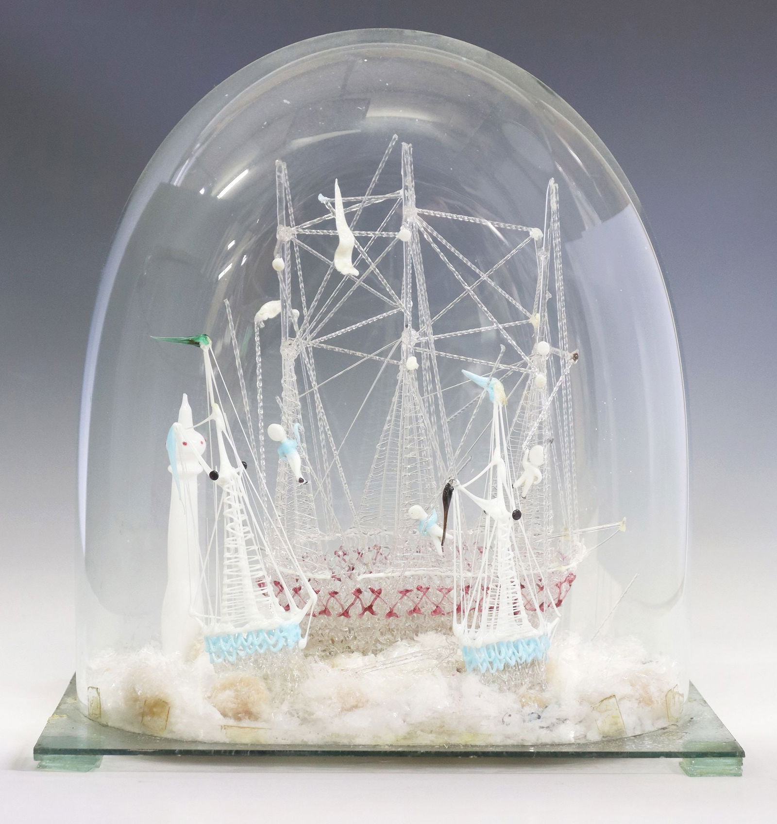 VICTORIAN LAMPWORK ART GLASS SAILING SHIP MODEL IN CLOCHE: Victorian lampwork art glass model sailing ship, late 19th c., with twisted rod rigging and colored accents, housed in glass cloche affixed to glass base, overall with breaks and losses, approx 16&quo
