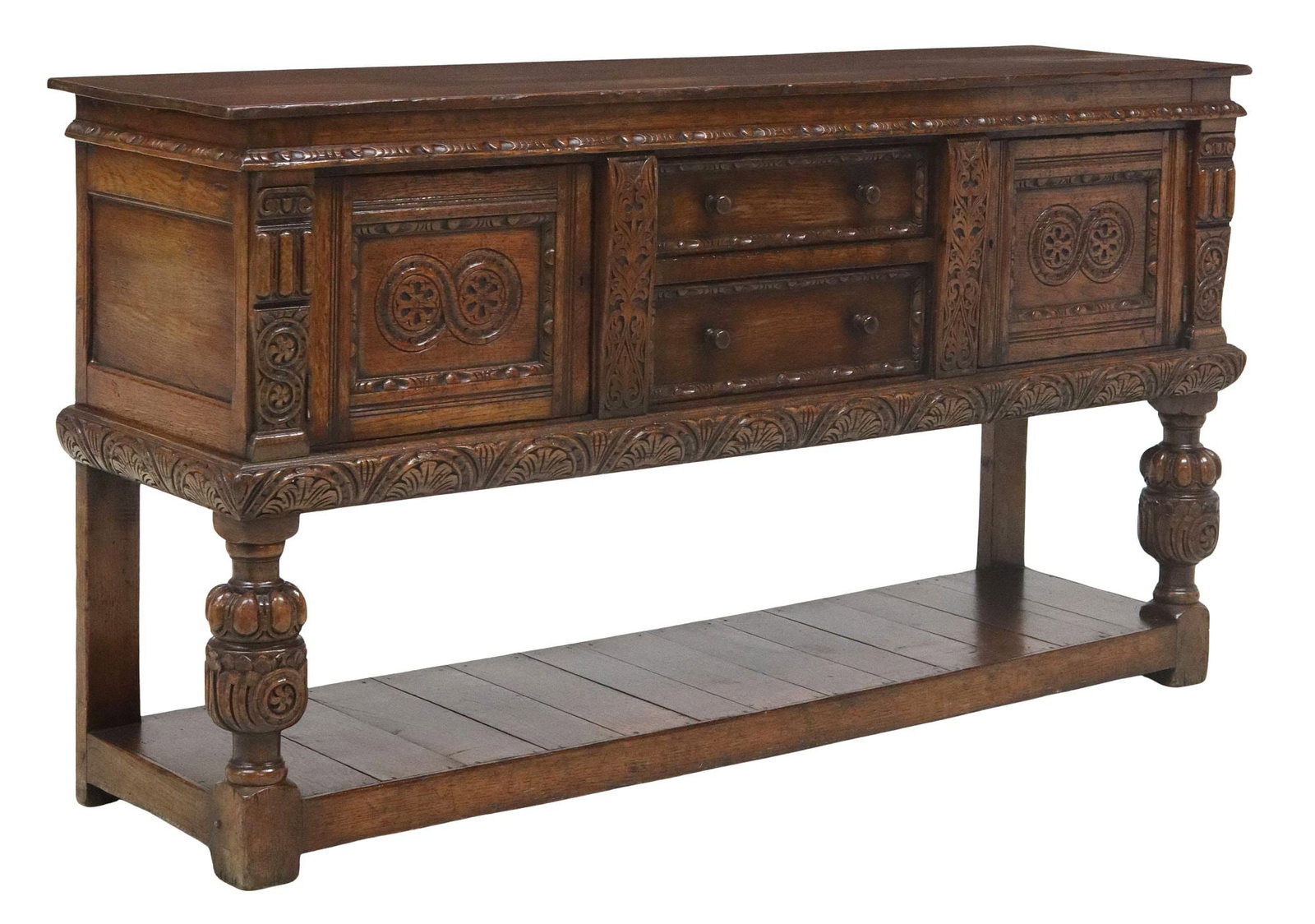 ENGLISH CARVED OAK SIDEBOARD: English carved oak sideboard, 20th c., two centered drawers, flanked by side cabinets, on bulbous supports, approx 35.75"h, 66"w, 17.75"d