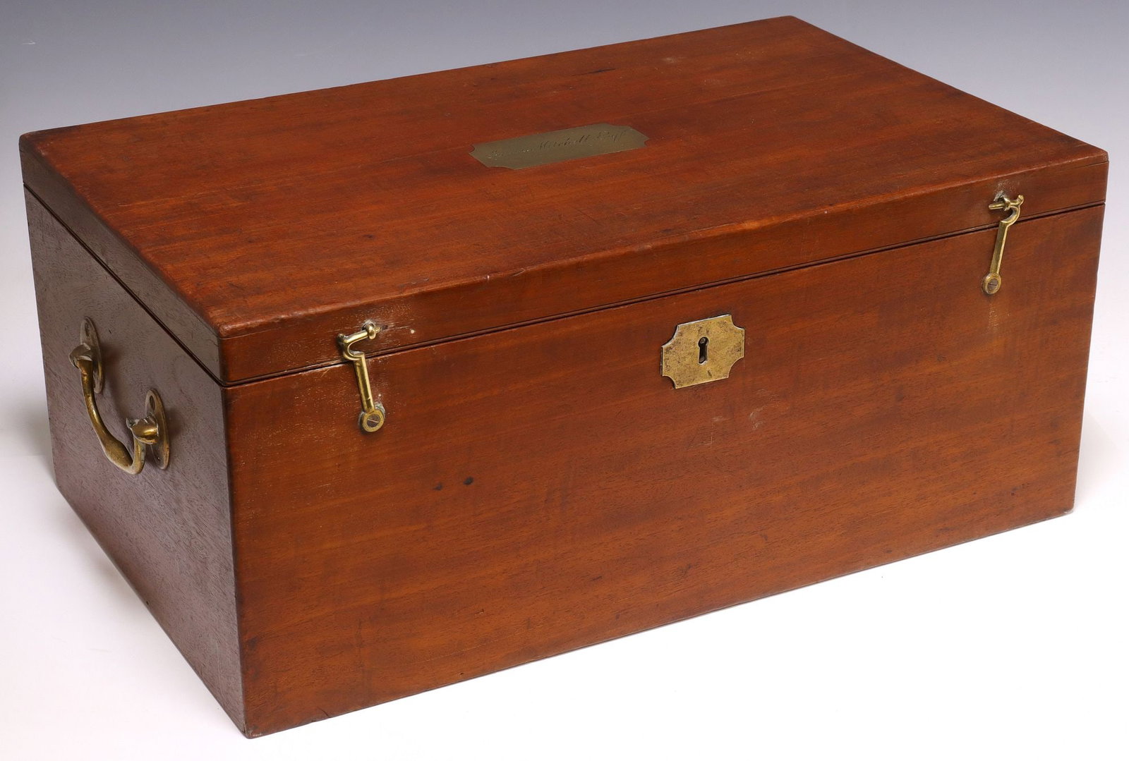 LARGE ASPREY & CO. BRASS-BOUND MAHOGANY FITTED FLATWARE STORAGE BOX: Large English mahogany flatware storage box, Asprey & Company Silversmiths, late 19th c., rectangular case with dual brass side handles, hinged lid with cartouche marked James Mitchell, Esq.,