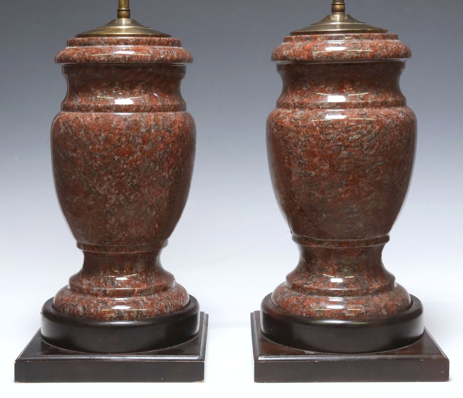 (2) TURNED & POLISHED RED GRANITE TWO-LIGHT TABLE LAMPS: (pair) Granite table lamps, two positionable lights on pull chains, turned and polished red granite stem, on a wood plinth, granite: approx 11.75"h, overall: approx 26"h, 8.25"w, 8.25&q