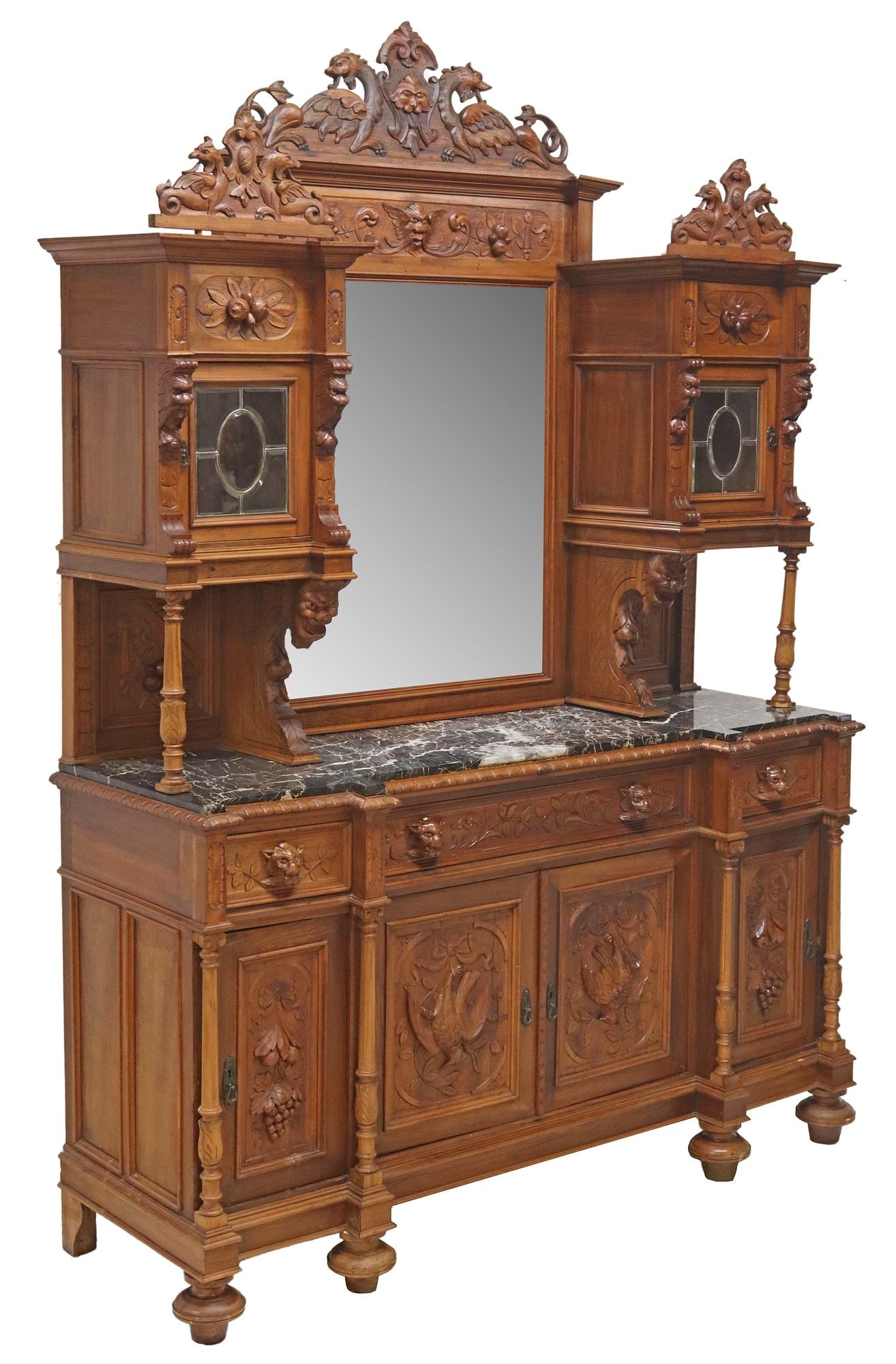 ITALIAN CARVED WALNUT MIRRORED HUNT SIDEBOARD: Italian carved walnut hunt sideboard, 19th c., having figural shield-form crests depicting opposing grotesques, central beveled mirror plate, flanked on both sides by cabinet with beveled glass door,&