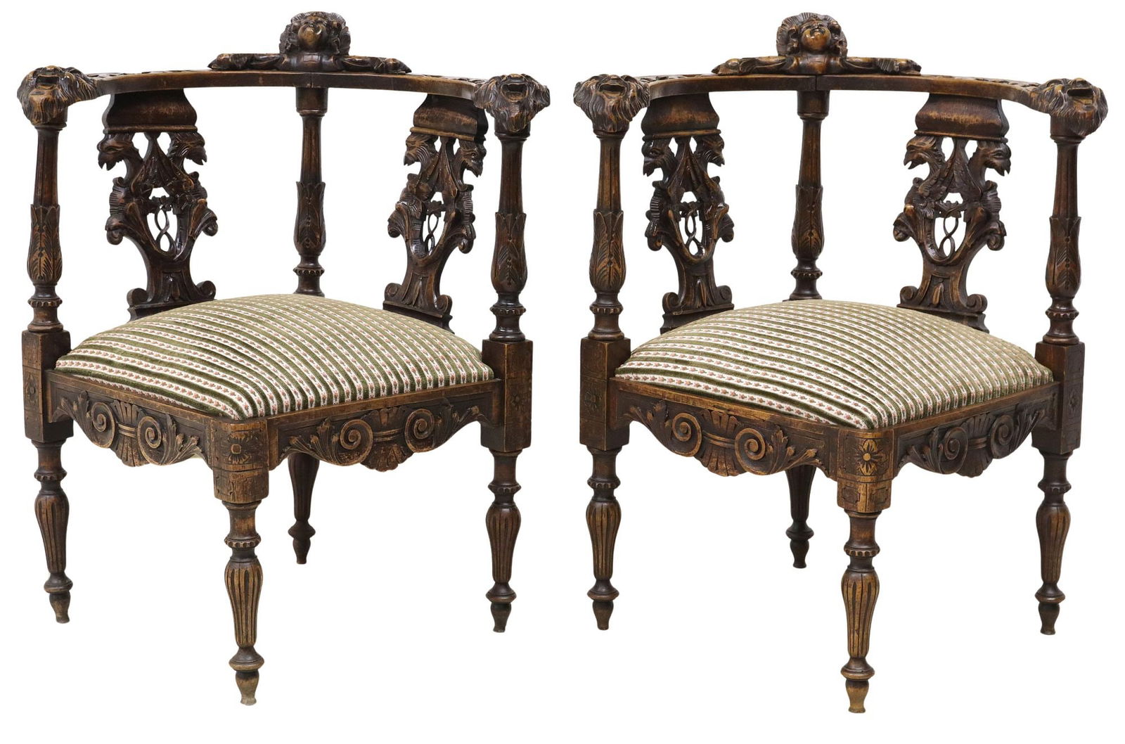 (2) FRENCH RENAISSANCE REVIVAL CARVED & UPHOLSTERED CORNER CHAIRS: (pair) French Renaissance Revival carved corner chairs, early 20th c., each having mask crest in fanned surround, pierced splat with winged griffons, figural grotesque mask handholds, padded seat in s
