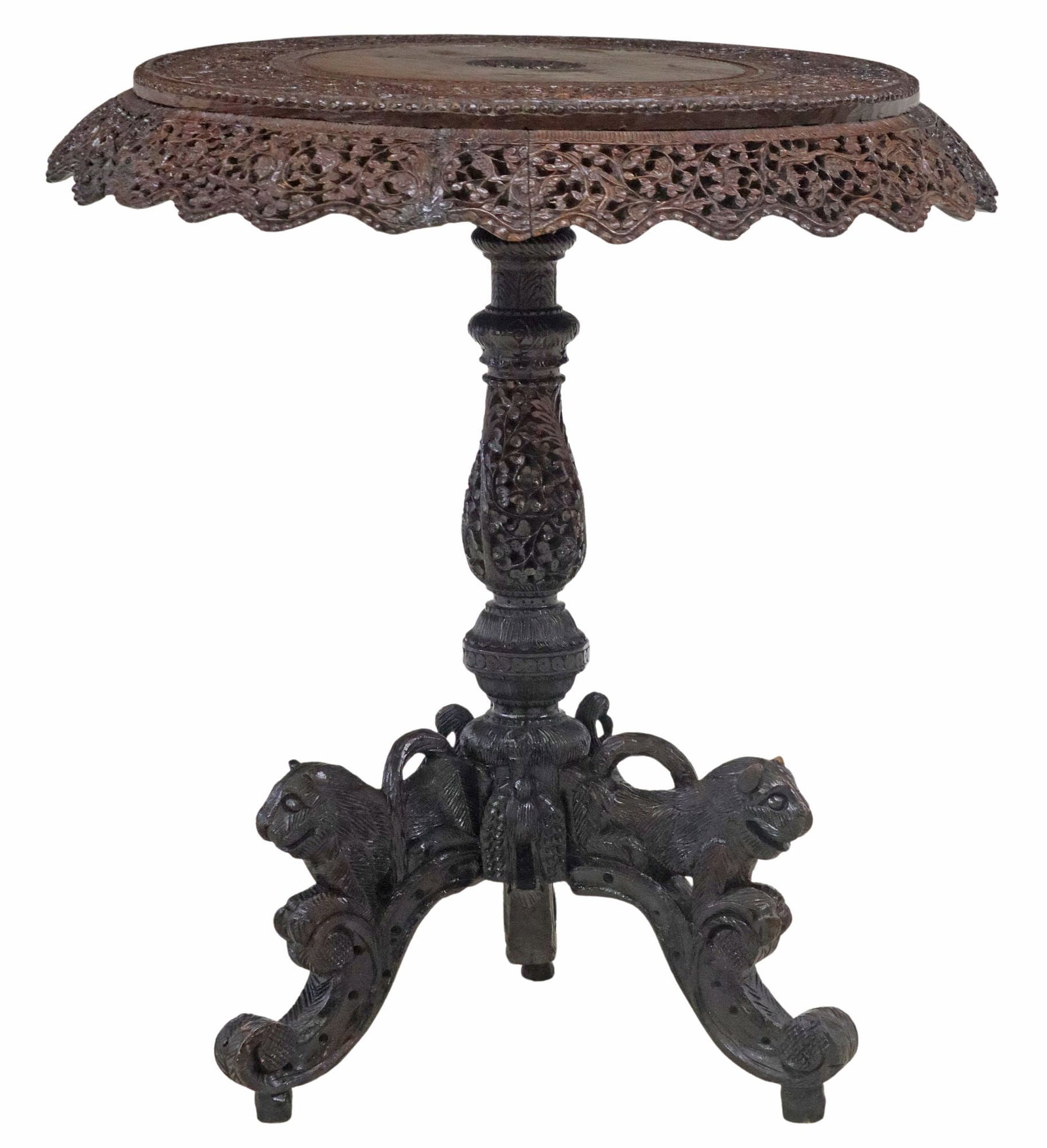 ANGLO-INDIAN CARVED HARDWOOD LIONS PEDESTAL SIDE TABLE: Anglo-Indian or Burmese carved hardwood pedestal table, having circular top with central floral medallion, scrolled foliate scalloped apron, over turned standard, rising on tripod base with figur