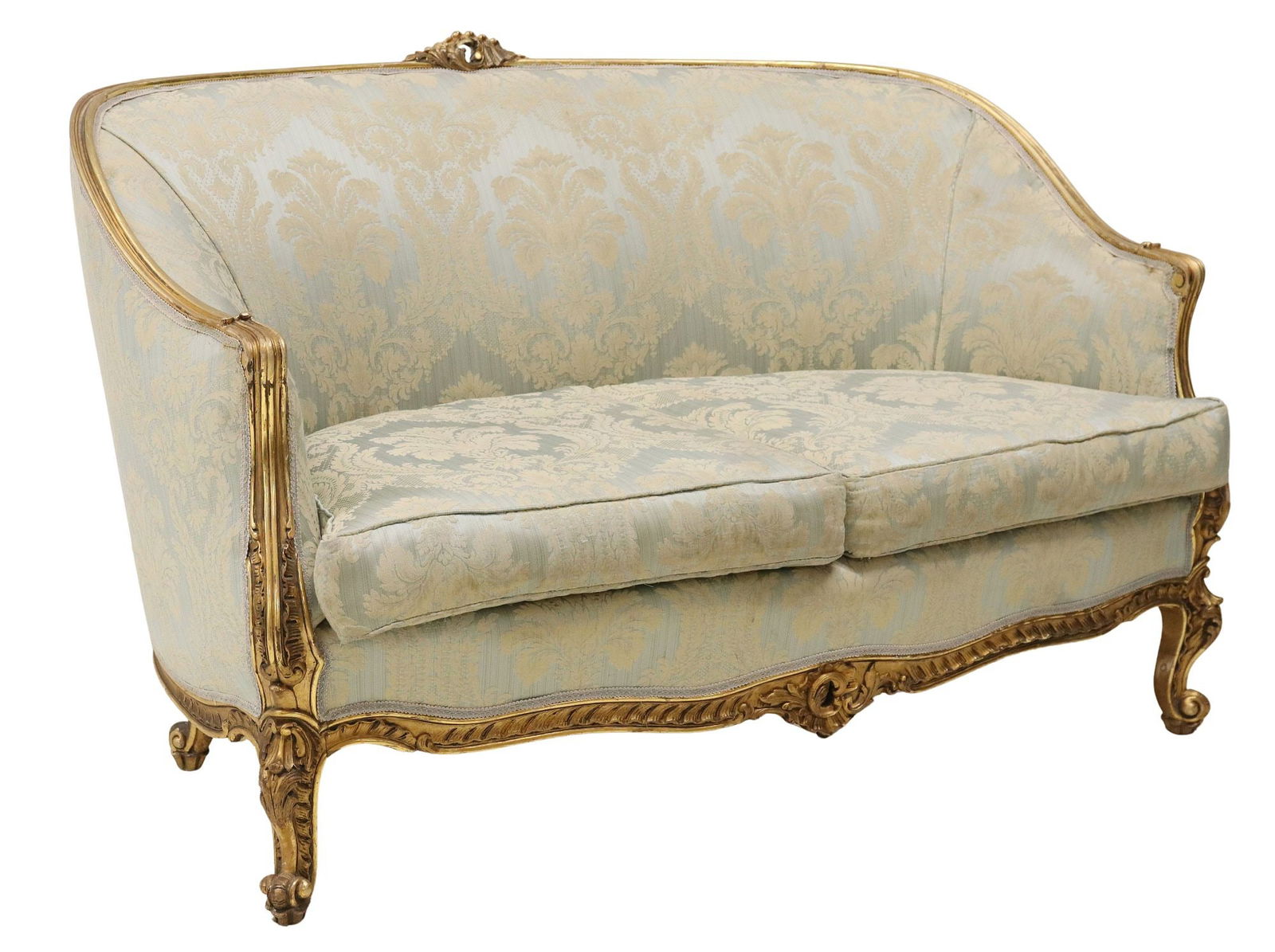 LOUIS XV STYLE UPHOLSTERED GILTWOOD CANAPE SOFA: Louis XV style giltwood salon settee, 20th c., having fanned crest, above rounded back and arms, in patterned damask upholstery, with ribbon trim, removable seat cushions, rising on short cabriol