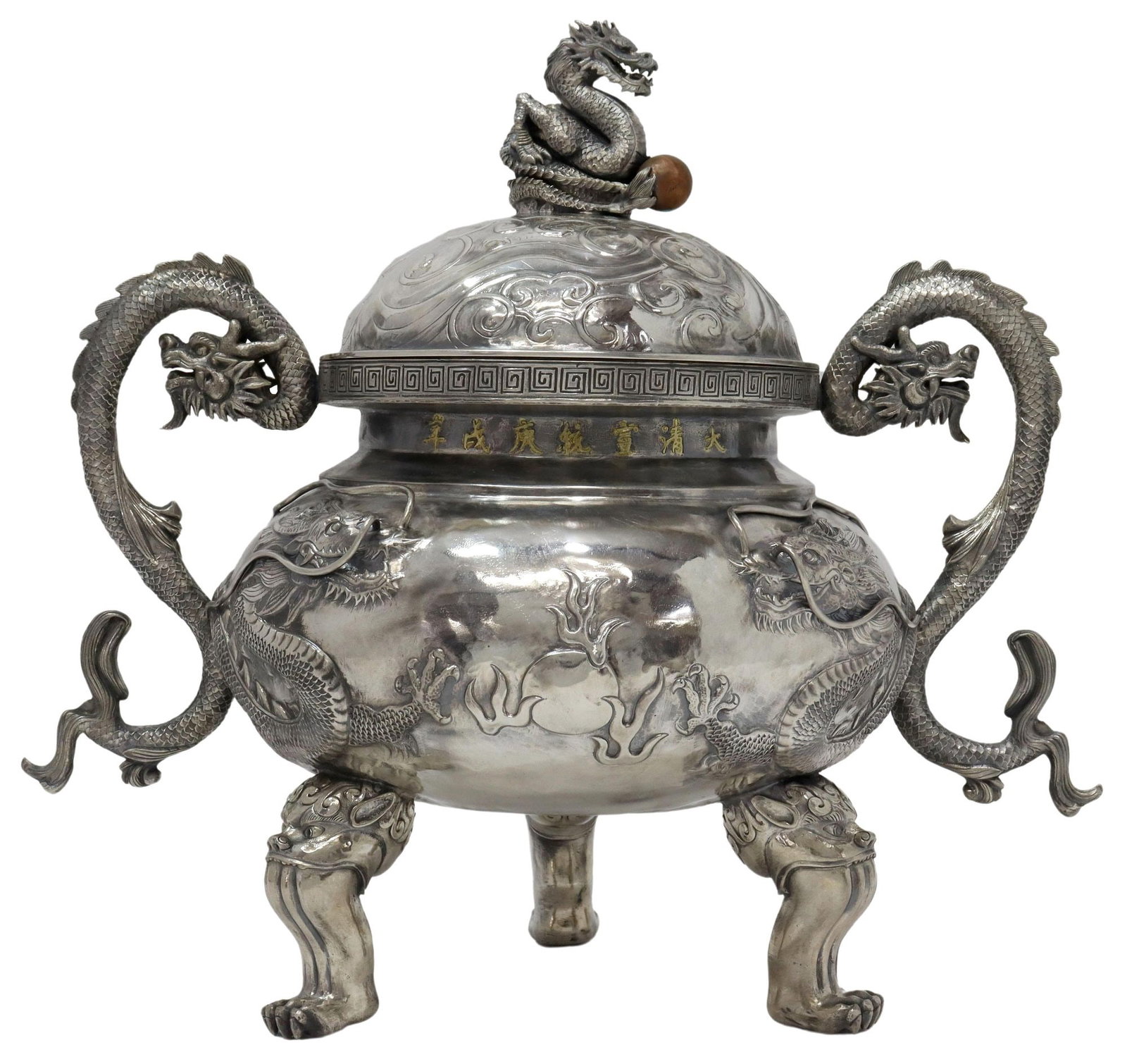 CHINESE STERLING DRAGON INCENSE BURNER-FORM URN: Chinese sterling silver incense burner-form urn, early 20th c., finial modeled as a dragon clutching a pearl, domed lid with stylized cloud scrolls, meander border above seven-character mark highlight