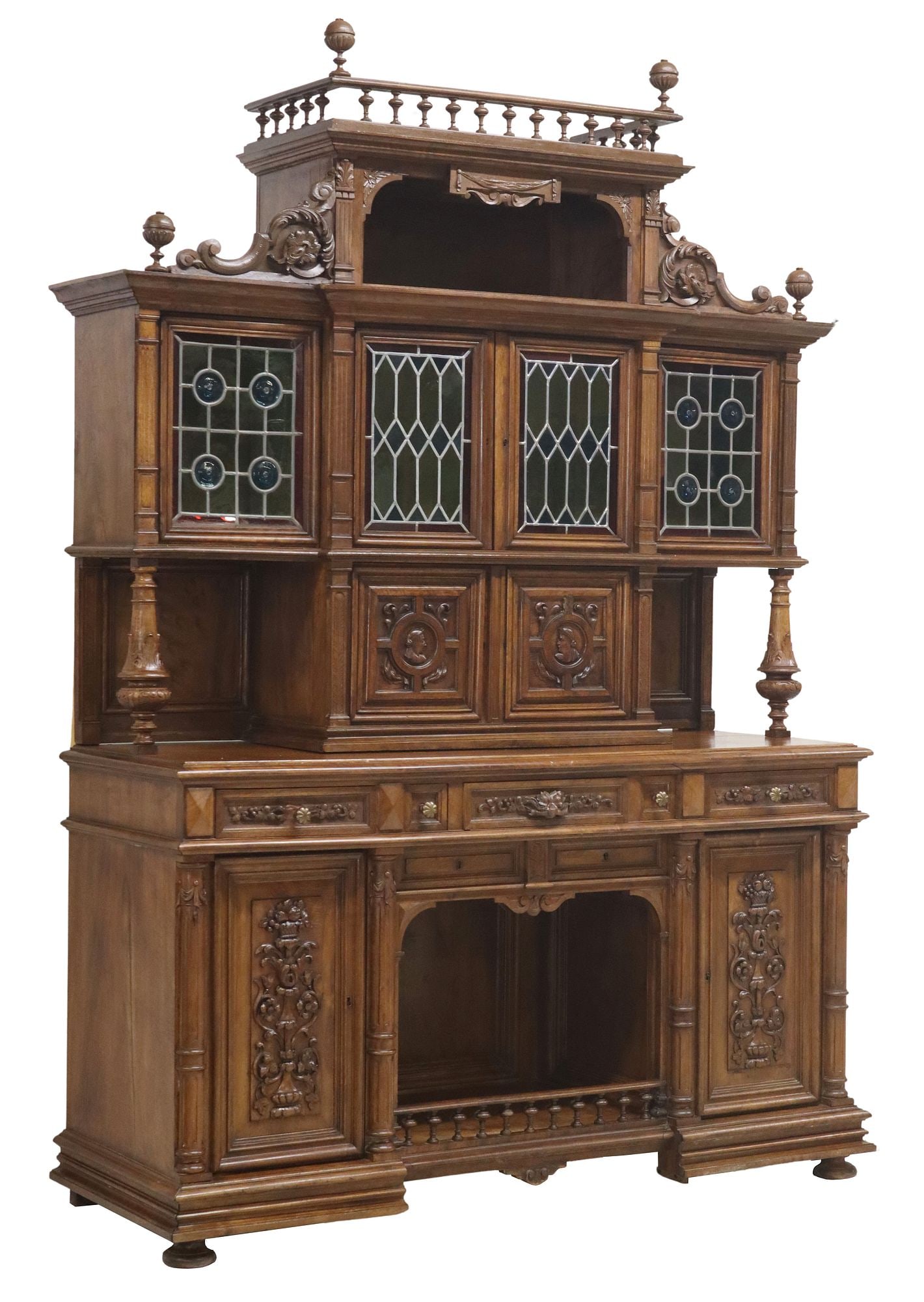 FRENCH CARVED WALNUT SIDEBOARD WITH STAINED & LEADED GLASS: French carved walnut sideboard, late 19th c., stained and leaded glass doors, outer two with bullseye/ crown glass roundels, above double-door cabinet with portrait medallions, lower case fitted with 