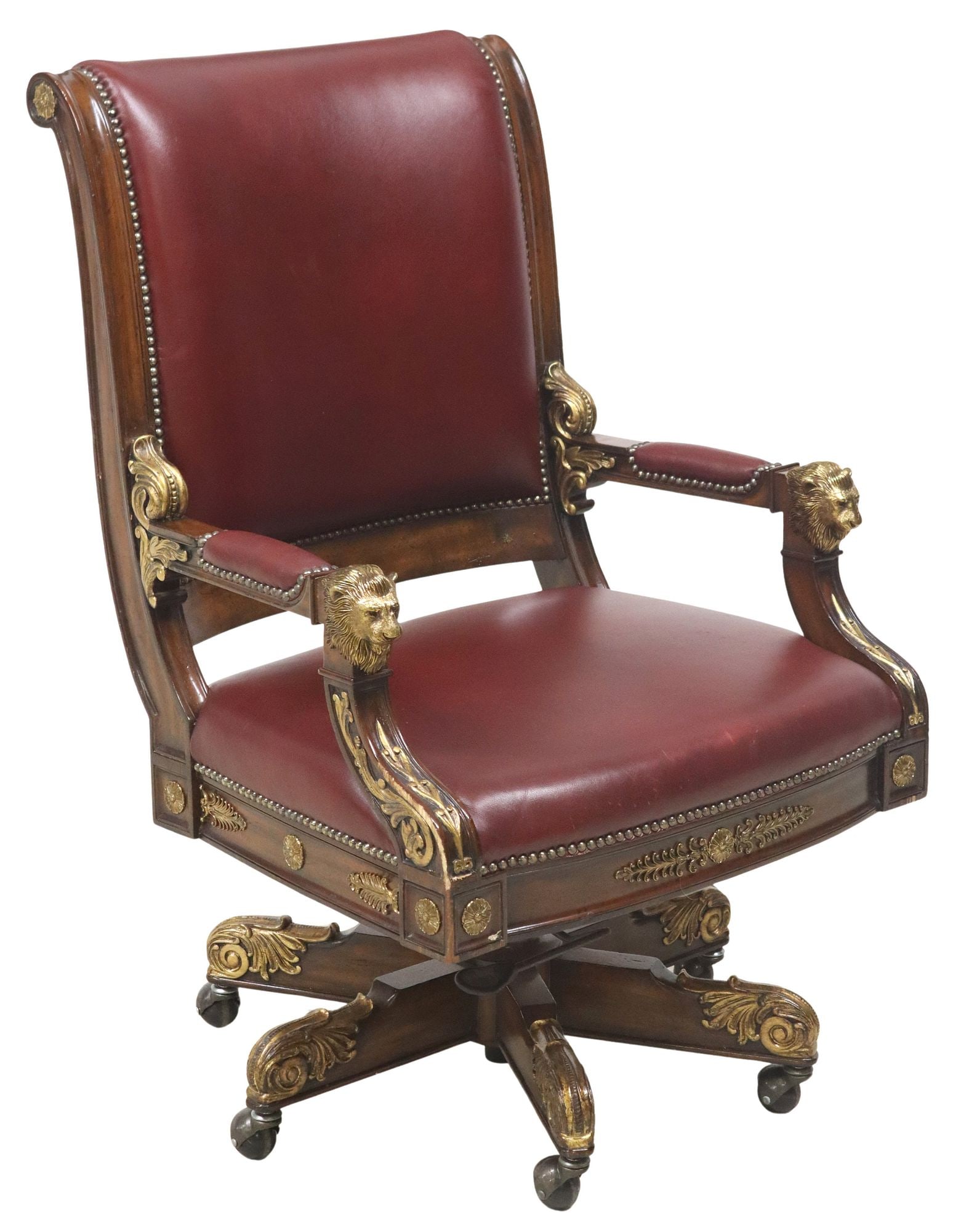 BURGUNDY LEATHER & LION MASK HANDHOLD EXECUTIVE OFFICE SWIVEL DESK CHAIR: Executive office swivel desk chair, late 20th c., having padded back, arms, and seat in burgundy leather upholstery, with nailhead trim, gilt metal mounts and gilt painted scroll motifs, lion mask han