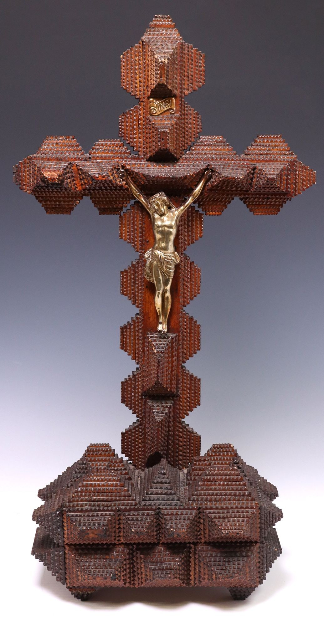 LARGE TRAMP ART CHIP CARVED WOOD CRUCIFIX, 27.25"H: Tramp Art wood crucifix, early 20th c., chip carved cross and rectangular pointed base, gold-tone metal Corpus Christi, approx 27.25"h, 14.75"w, 6.5"d, 5lbs