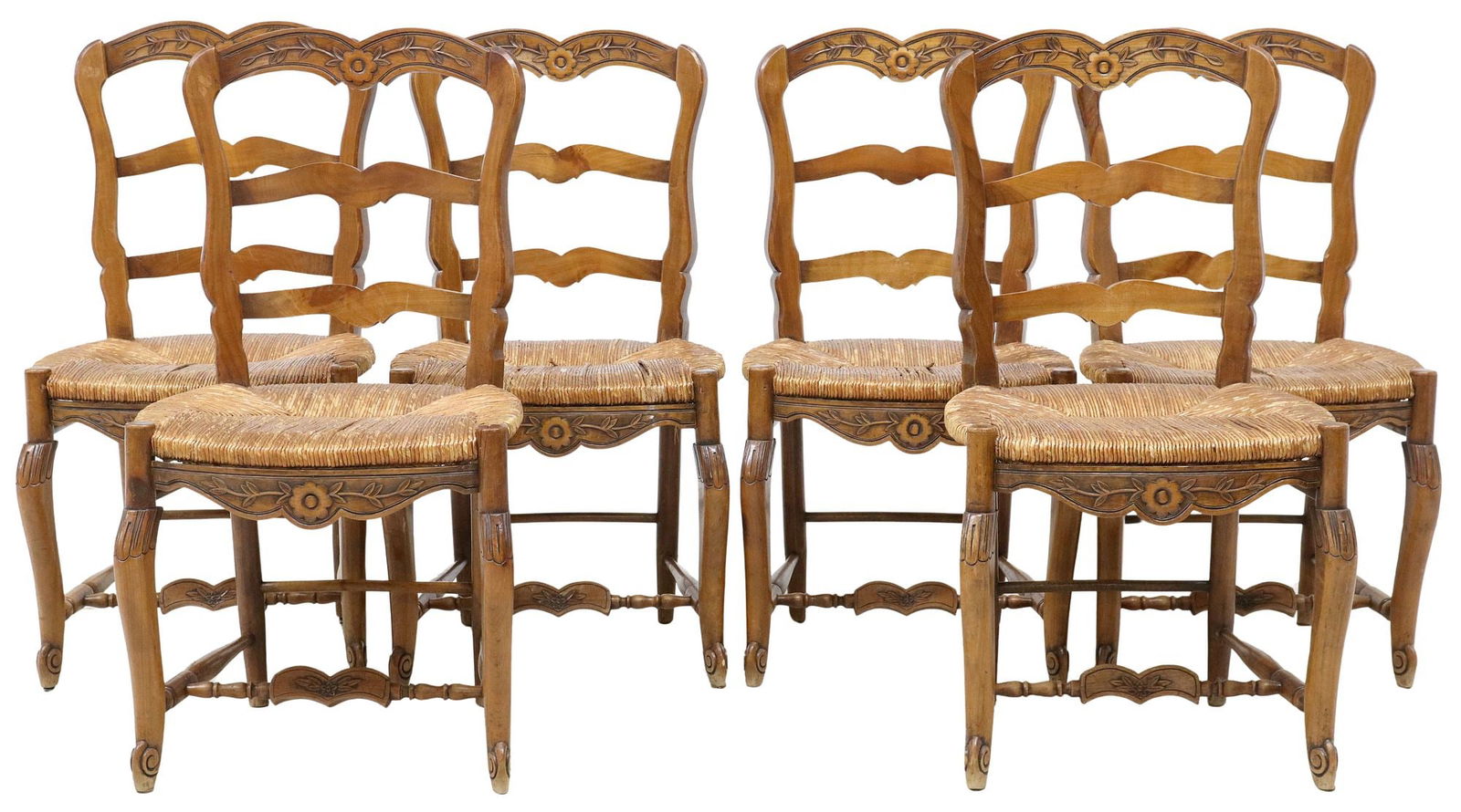 (6) FRENCH PROVINCIAL FRUITWOOD LADDERBACK RUSH SEAT CHAIRS: (lot of 6) French Provincial ladderback fruitwood dining chairs, late 19th c., each having scalloped top rail with carved floral medallion, above rush seat, rising on stretcher-joined cabriole legs, a