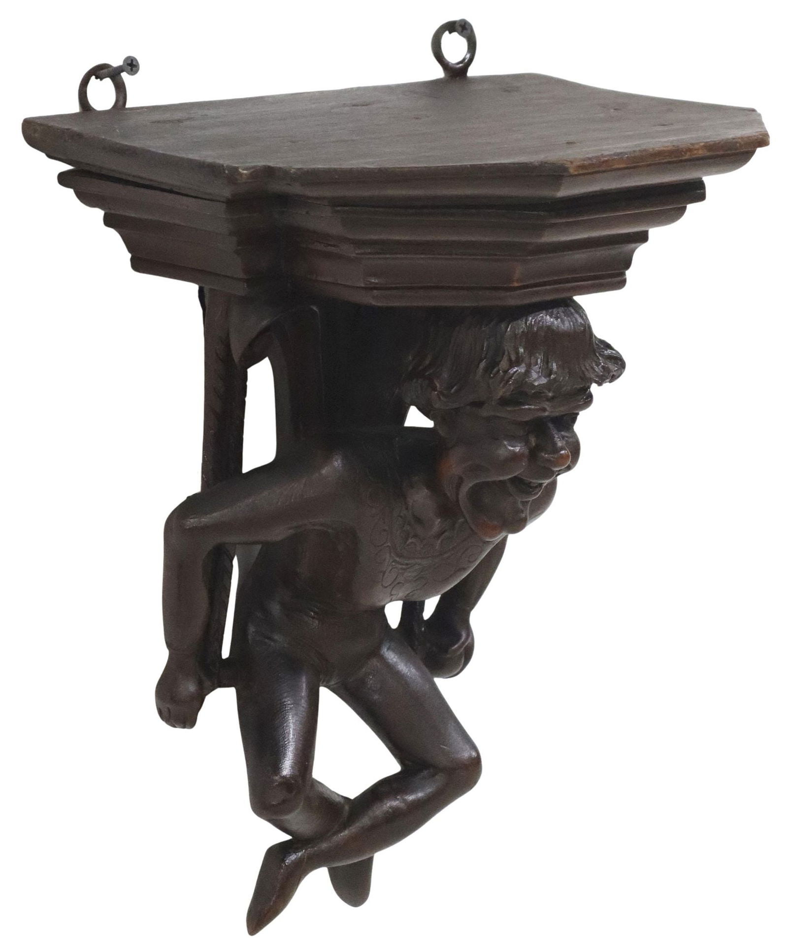 ITALIAN CARVED WOOD FIGURAL WALL BRACKET: Italian carved wood wall bracket, late 19th c., stepped molded shelf, supported by a caricatural figure seated on a trapeze, approx 13.5"h, 11"w, 8.5"d, 3.25lbs