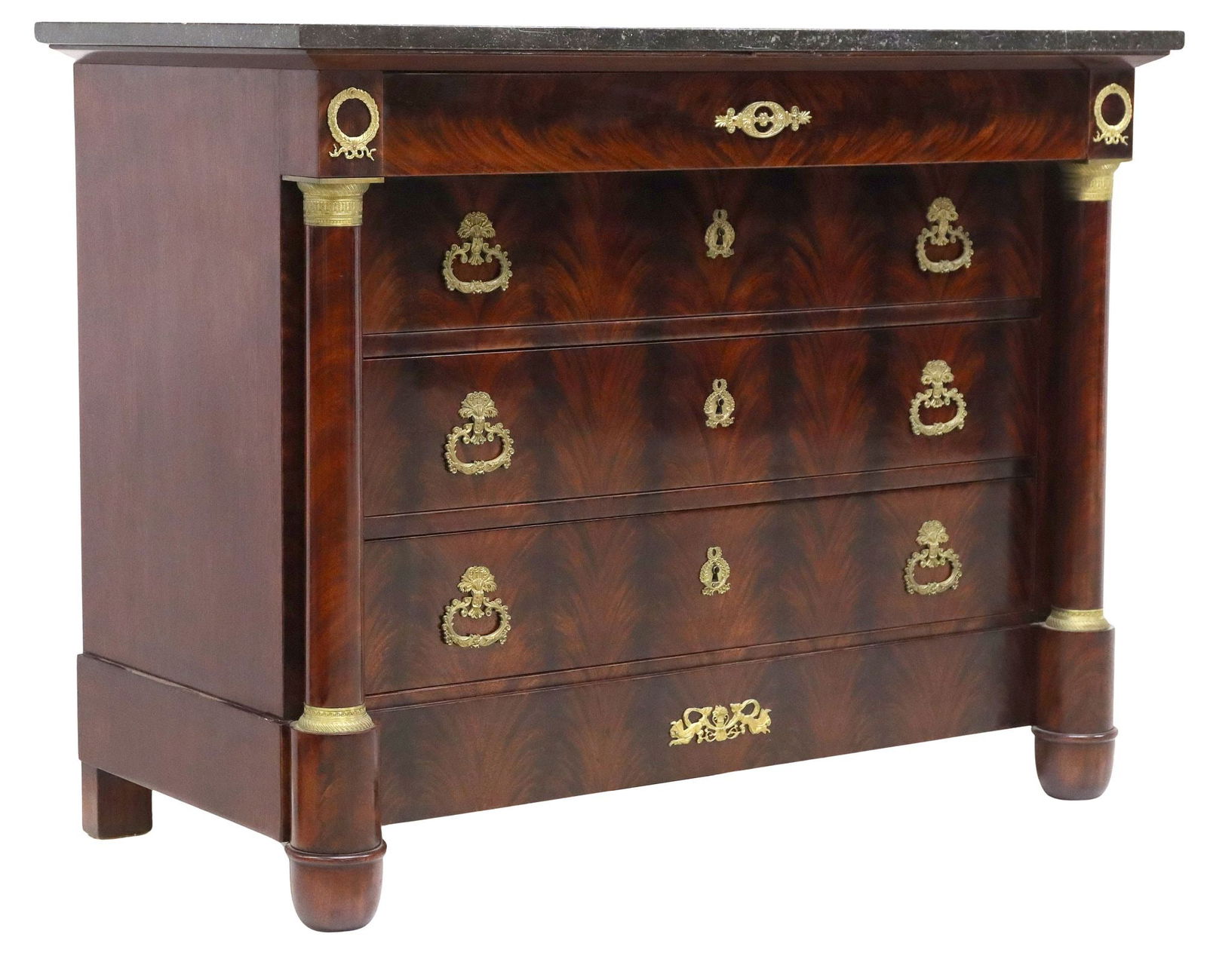 FRENCH EMPIRE STYLE MARBLE-TOP FLAME MAHOGANY COMMODE: French Empire style flame mahogany commode, late 19th c., having marble top, over frieze drawer, and three standard drawers, flanked by columnar corner posts mounted with gilt metal capitals and wreat