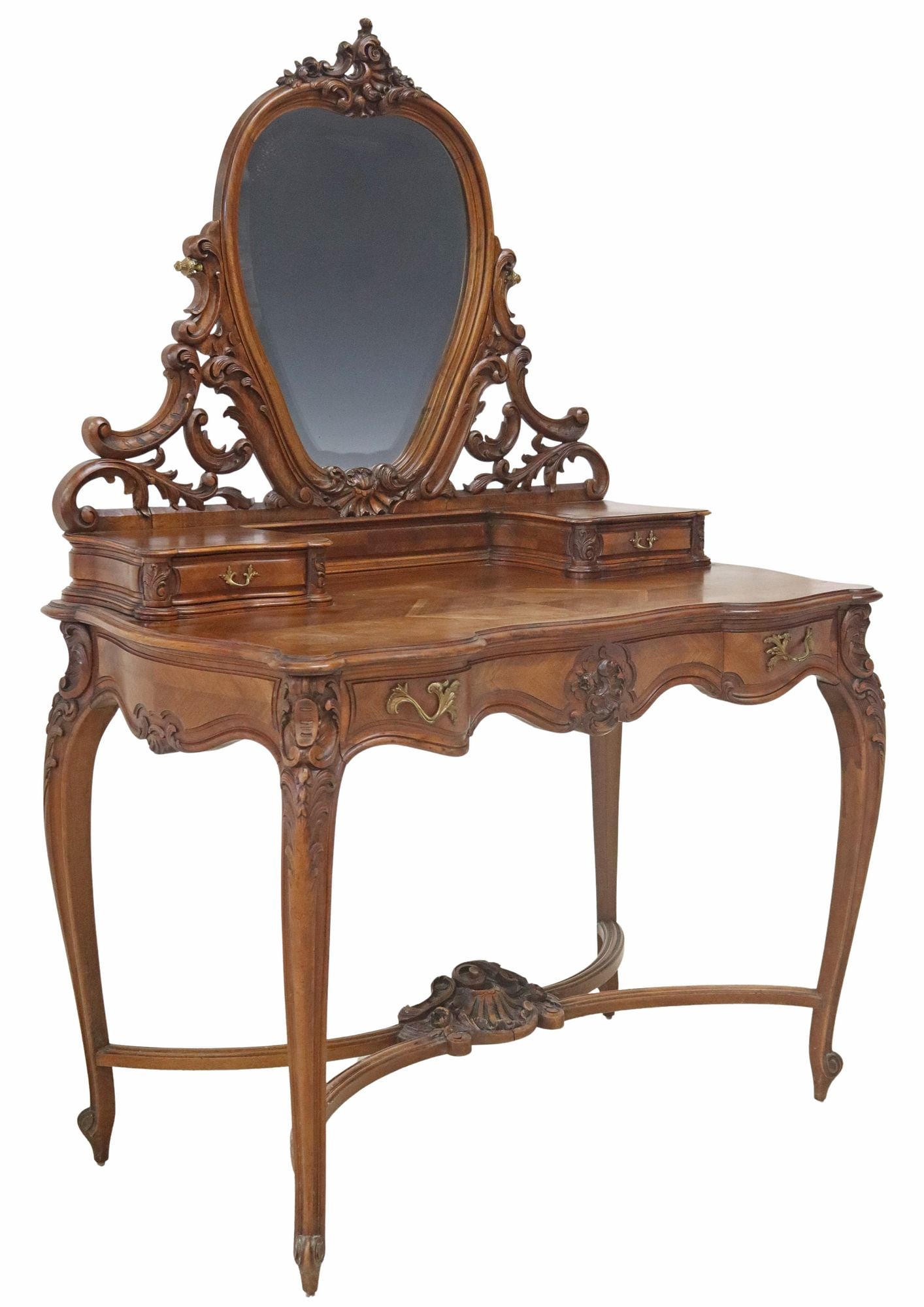LOUIS XV STYLE MATCHED VENEER MIRRORED VANITY TABLE: Louis XV style matched veneer mirrored vanity/ dressing table, early 20th c., having swiveling beveled mirror, tabletop with two small drawers, above three standard drawers, rising on stretcher-joined