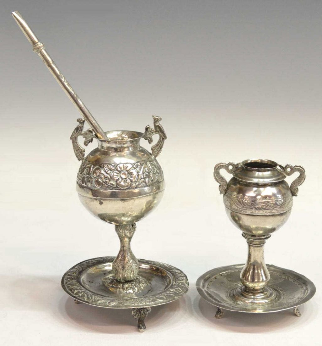 (3) VINTAGE SOUTH AMERICAN SILVER PLATE MATE CUPS: (lot of 3) South American silver mate cups and bombilla, Chile, comprising: (1) repousse floral band, fish form handles, rising on a conforming plate, three paw feet, 5.75"h; (1) scrolled foliate band