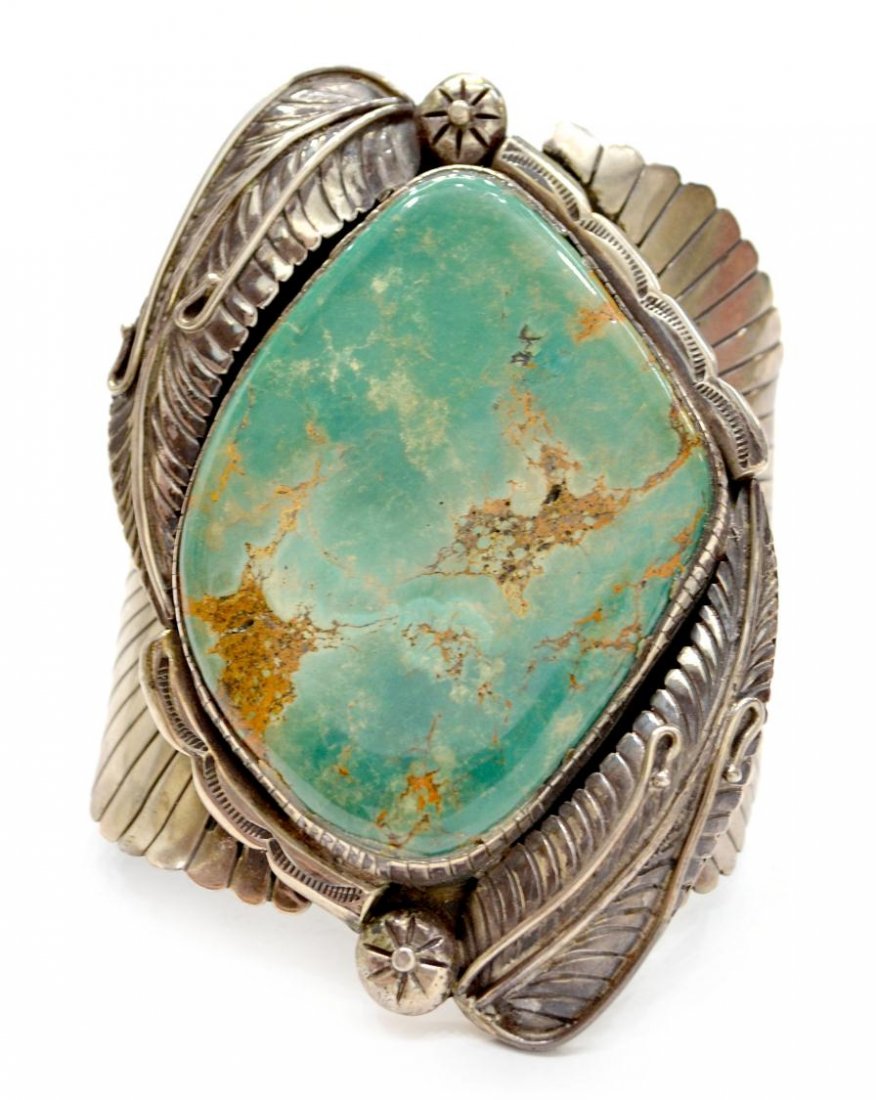 MENS VINTAGE NATIVE AMERICAN TURQUOISE SILVER CUFF: Vintage Old Pawn Navajo silver and turquoise men's cuff bracelet, seven bands hold the feathered bezel worked in silver enclosing a large turquoise stone of greenish blue, seven bands, approx 4.5"l, 3