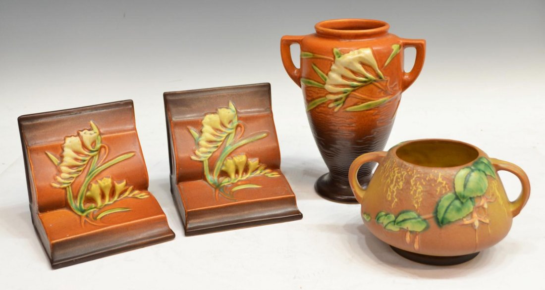 (4) ROSEVILLE ART POTTERY GROUP, FREESIA & FUSCHIA: (lot of 4) Roseville art pottery group, comprising: (pair) 'Freesia' book ends, brown ground with clusters of freesia flowers and leaves, numbered 15, 5.25"h, 5.25"w, 4.75"d; (1) double handled 'Frees