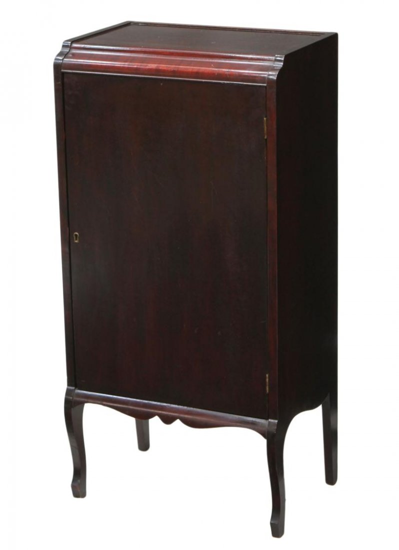 AMERICAN MAHOGANY MUSIC CABINET & SHEET MUSIC: American mahogany record cabinet, c. 1920, a waterfall front over a single door opening to interior shelves filled with a quantity of sheet music, music booklets, set on short cabriole legs, 38.5"h, 1