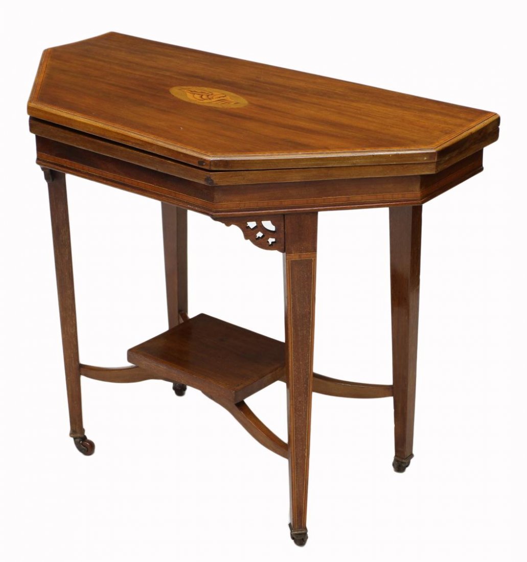 ANTIQUE HEPPLEWHITE REVIVAL FOLD TOP GAME TABLE: Hepplewhite Revival mahogany game table, c. 1900, the fold top with shell inlay opening to an octagonal game surface with felt inlay, set on squared tapered legs joined by a rectangular shelf, termina