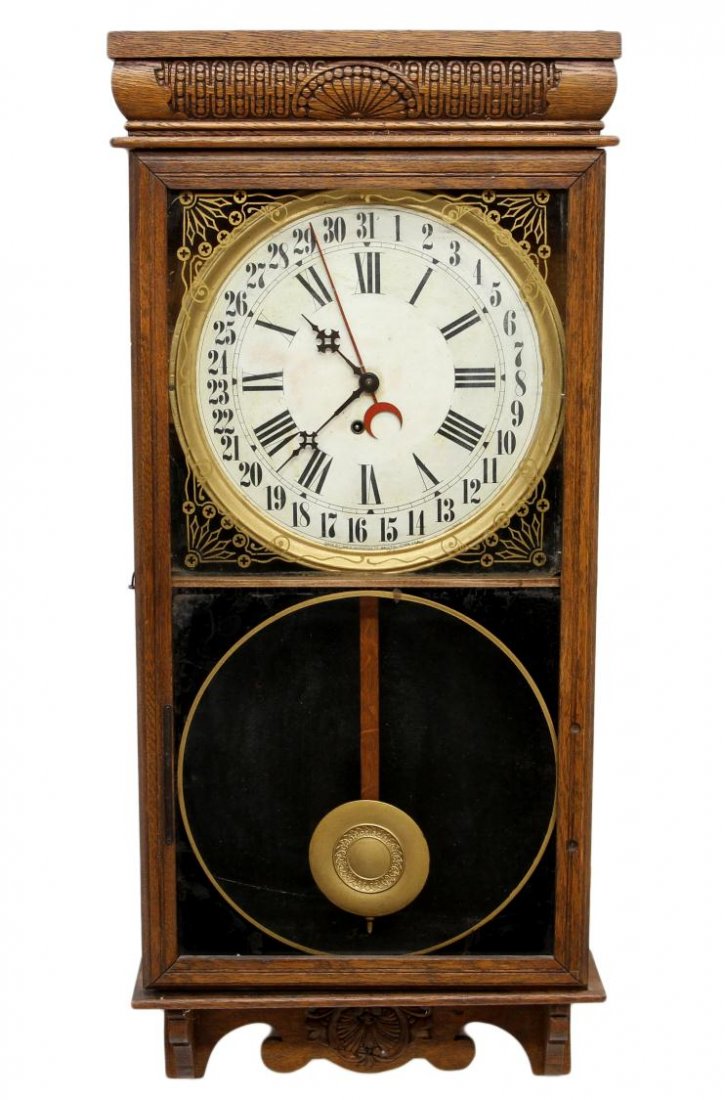 INGRAHAM CALENDAR REGULATOR CLOCK: Ingraham Co. oak school house clock, c. 1890's, time and calendar hands, gilt decoration, later lower glass gilt decorated panel, top panel with small crack at bottom corner, 37"h, 16.25"w, 4.5"d, 12.