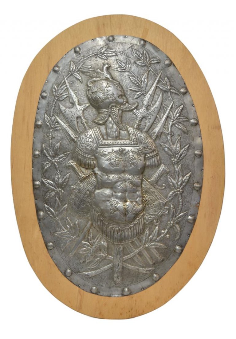 LARGE MEDIEVAL SOLDIER REPOUSSE WALL PLAQUE: Large oval repousse aluminum plaque, Medieval Soldier With Swords and Axes, mounted on board, plaque: 38"h, 25"w, wood mount: 44"h, 31"w, 18lbs Start Price: $100.00