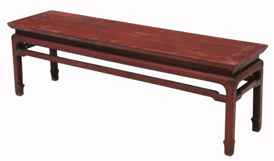 SOUTHEAST ASIAN RED LACQUER COFFEE TABLE: Southeast Asian red lacquer low table, long rectangular form having open work apron, rising on four square supports, splitting/wear with age, 21.5"h, 67"w, 17.5"d (8C065) Start Price: $100.00