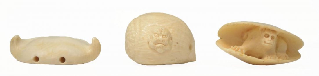 (3) JAPANESE IVORY NETSUKE & CARVED WATER CALTROP: ***International shipping is not available on this lot*** (lot of 3) Group of Japanese ivory netsuke, comprising: (1) formed as a water chestnut carved with two figural heads, 1.25"h; (1) carved as a 