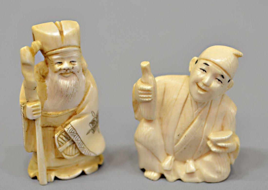 (2) JAPANESE CARVED IVORY NETSUKE, JUROJIN: *International shipping is not available on this lot* (lot of 2) Japanese carved ivory netsuke, including: (1) a figure of Jurojin standing with a staff and fan, signed Yukikazu, 2öh; (1) an inebriat