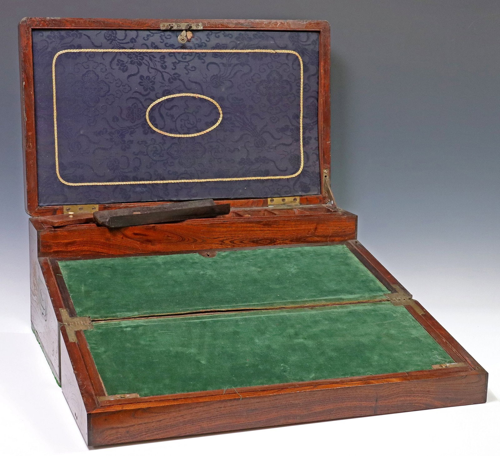ENGLISH CAMPHOR CAMPAIGN DESK/ WRITING SLOPE, 19TH C.: English metal-bound and inlaid camphor campaign desk/ writing slope, late 19th c., hinged top with inlaid gilt metal cartouche and banding, handles at either side, lid interior with damask-l
