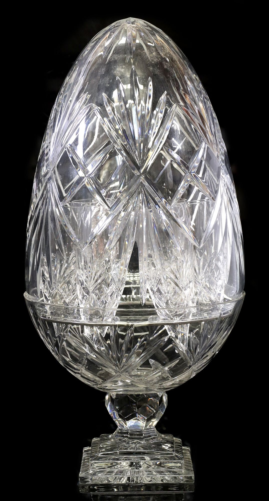 FRENCH CRYSTAL CAVE A CHAMPAGNE WITH STEMLESS FLUTES: French crystal champagne cellar, Brunner - Cristallerie des Vosges du Nord, 20th c., egg-form, with lift top, removable metal cradle, (six) stemless champagne flutes, on a stepped square pli