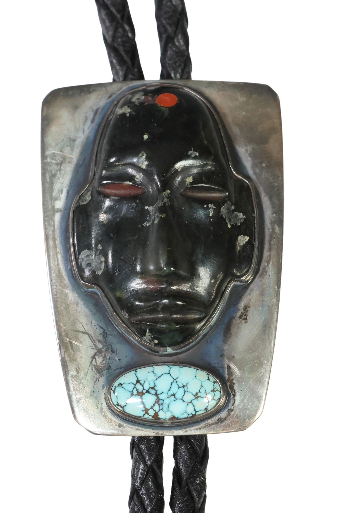 FRANK PATANIA, JR. (B.1932) STERLING SILVER, HARDSTONE MASK & TURQUOISE BOLO TIE: Southwest sterling silver bolo tie, Frank Patania, Jr. (Santa Fe, New Mexico, b.1932), Mexican Pre-Columbian style carved hardstone mask, oval cabochon spiderweb turquoise, silver-tone metal bolo tips