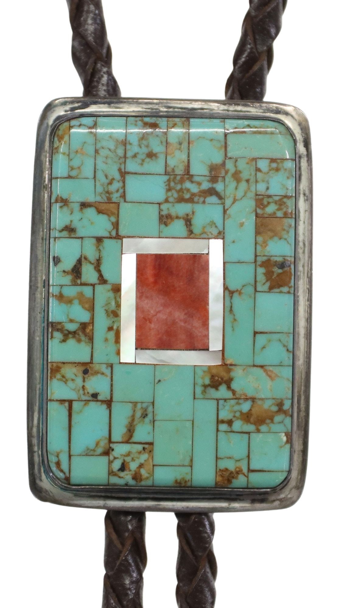 CHARLIE BIRD (B.1943) KEWA-LAGUNA TURQUOISE MOSAIC INLAY BOLO TIE: Native American silver (content unknown) bolo tie, Charlie Bird (Kewa-Laguna, b.1943), rectangular plaque with mosaic inlay red spiny oyster shell, white shell and turquoise, silver bolo tips, braided
