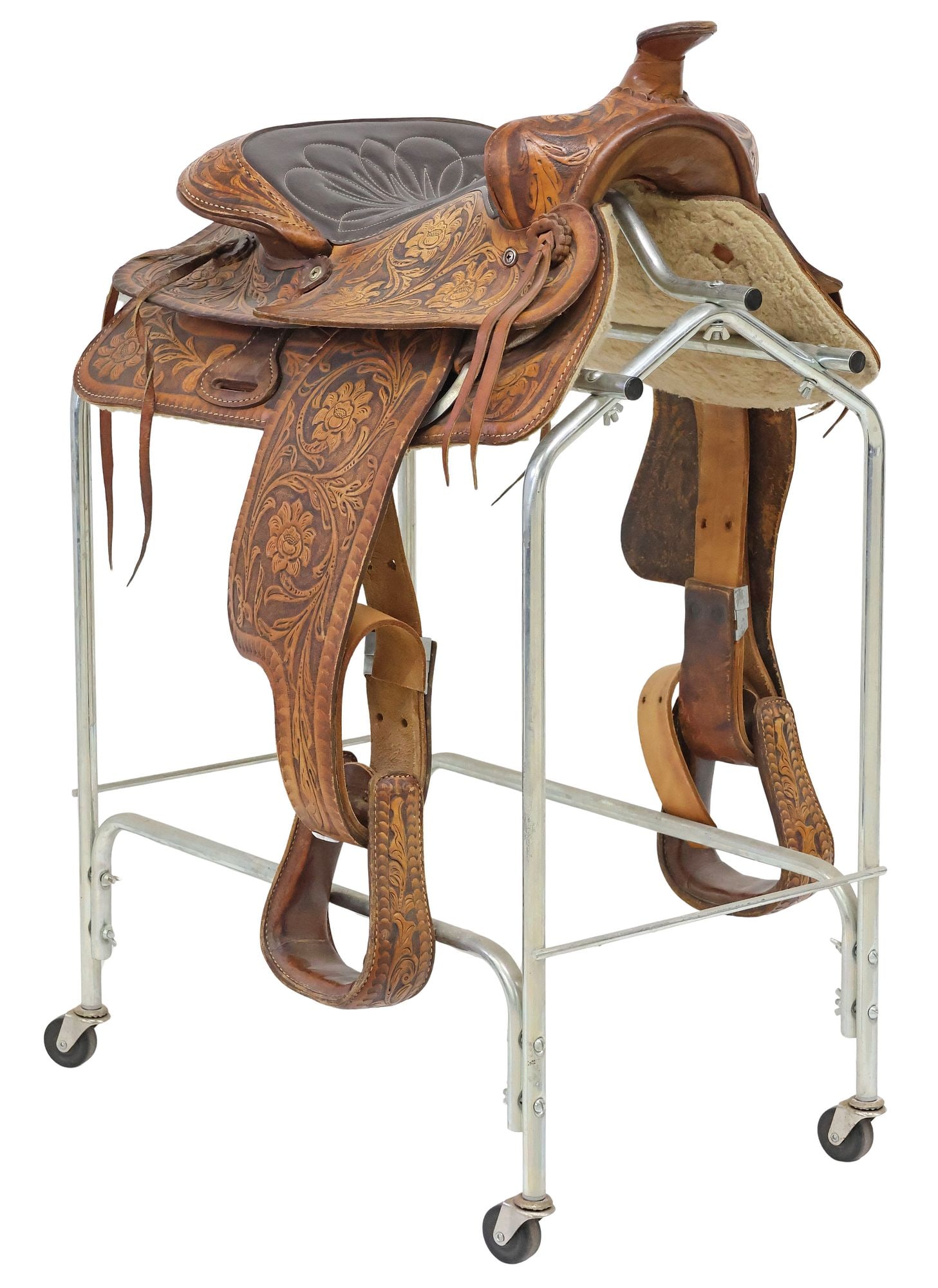 WESTERN BIG HORN SADDLERY TOOLED BROWN LEATHER SADDLE & STIRRUPS: Western tooled brown leather saddle, Big Horn Saddlery, 14" seat, with tooled flowers and foliate scrollwork, stitched seat, stamped maker's mark to fender, accompanied by matched stirrups