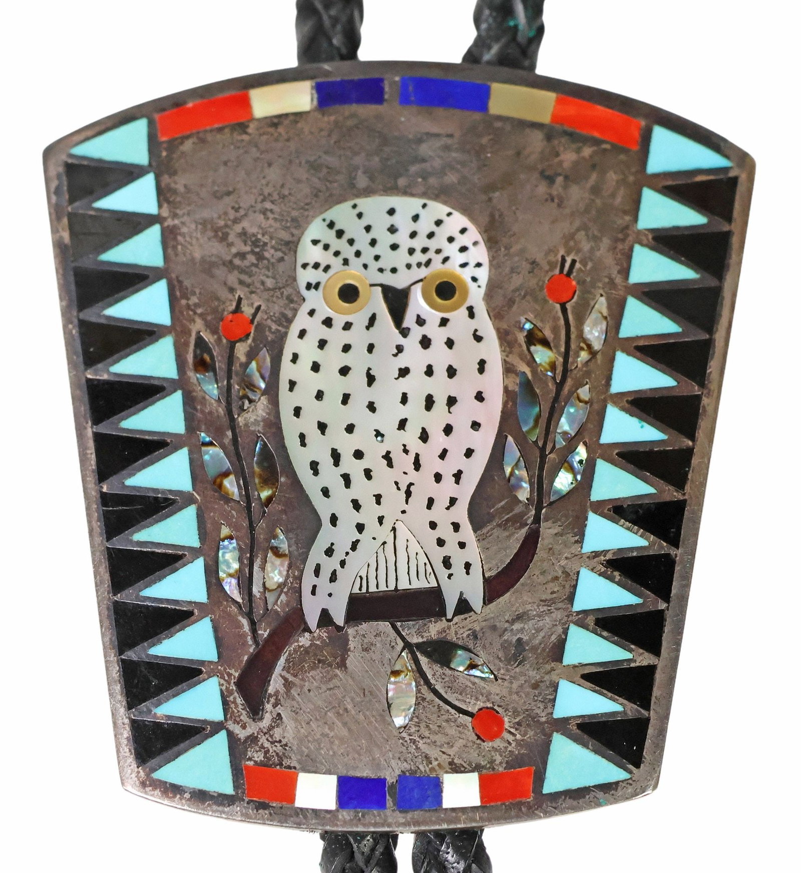 DENNIS & NANCY EDAAKIE ZUNI MULTI STONE INLAY SNOWY OWL BOLO TIE: Native American silver (content unknown) bolo tie, Dennis Edaakie (Zuni, Parrot-Macaw Clan, b.1931) and Nancy Edaakie (Zuni, Frog Clan, b.1937), oval plaque with shell-inlaid 