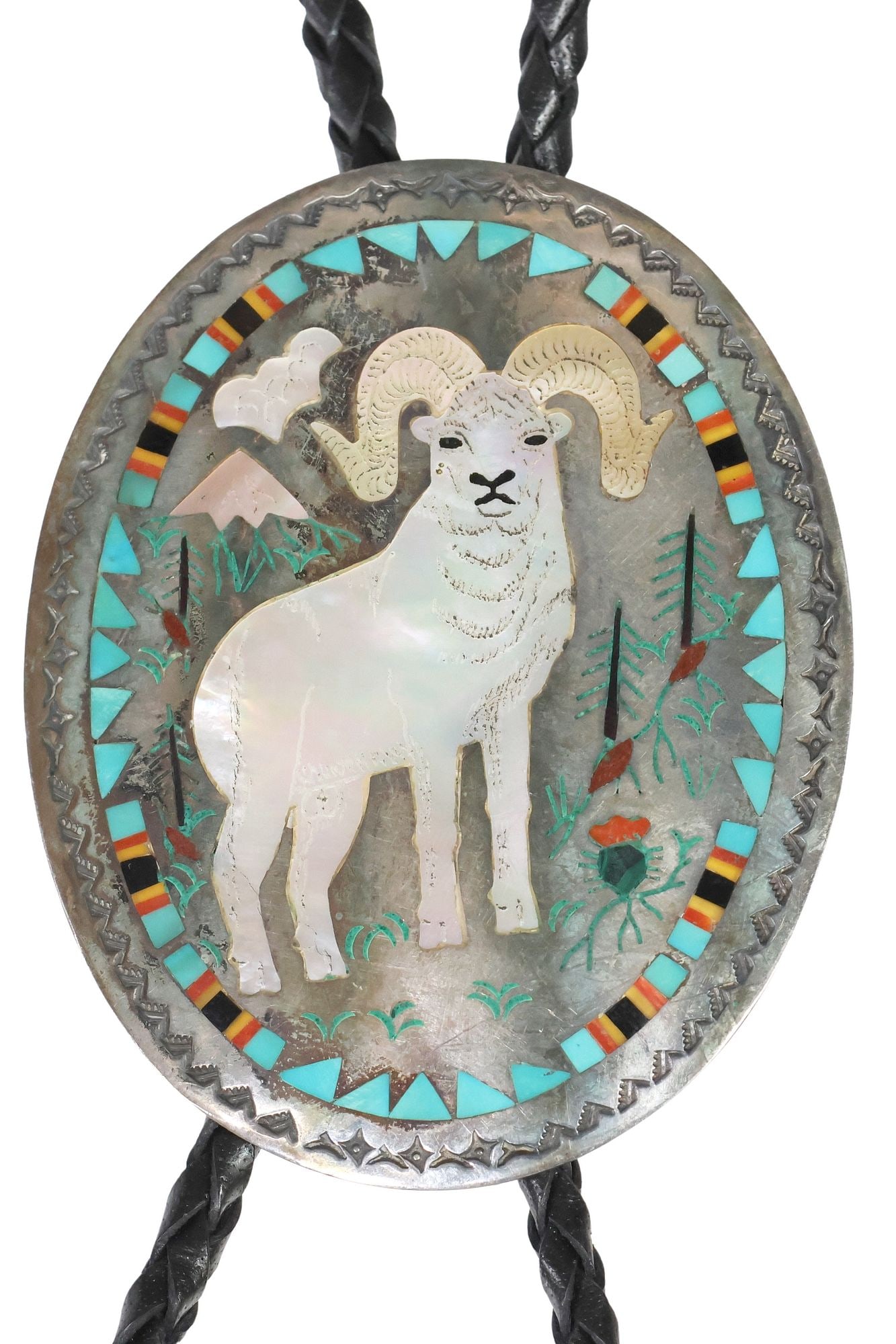 SAMMY & ESTHER GUARDIAN ZUNI MULTI STONE INLAY BIGHORN SHEEP BOLO TIE: Native American silver (content unknown) bolo tie, Sammy Guardian (Zuni, b.1951) and Esther Guardian (Zuni, b.1946), oval plaque with shell-inlaid bighorn sheep standing in a mount