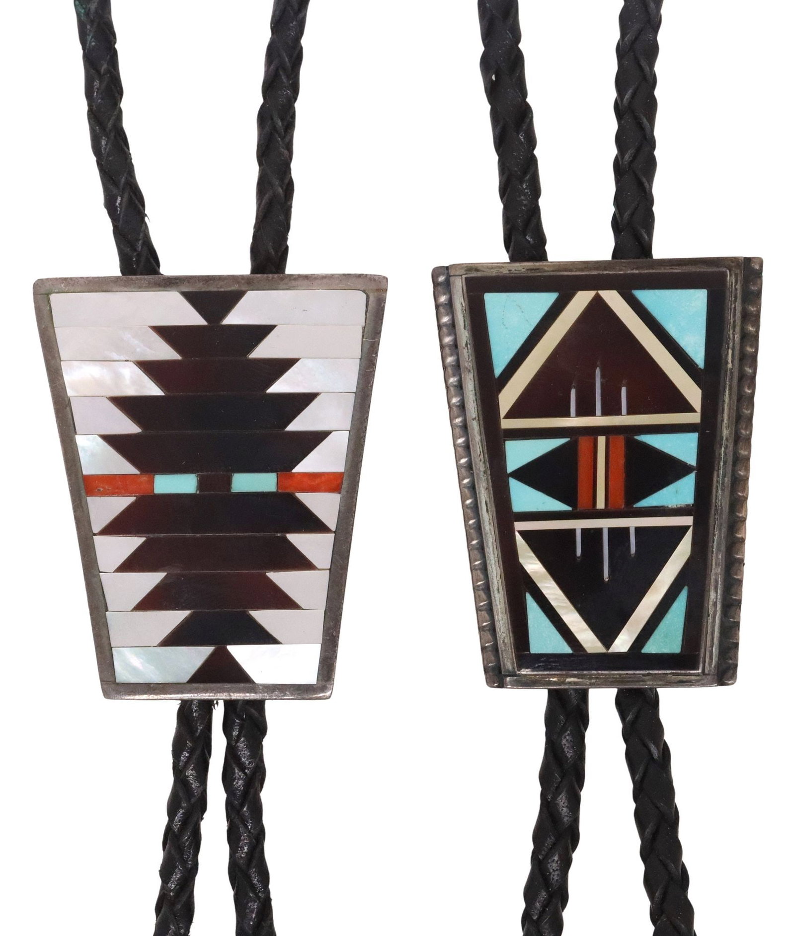 (2) RICK & LUCY VACIT & CHARLOTTE DISHTA ZUNI MULTI-STONE INLAY BOLO TIES: (lot of 2) Native American silver (content unknown) bolo ties, each with tapered plaque in a geometric pattern, on a braided black leather cord, ending in silver-tone tips, including: (1) Ri