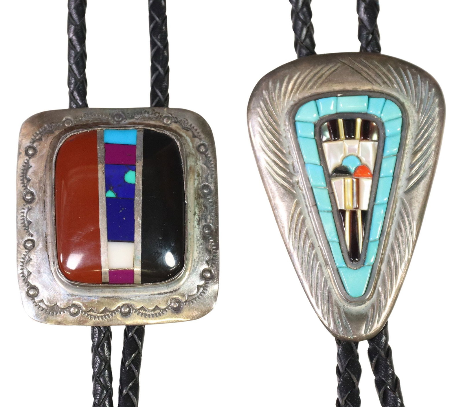 (2) ZUNI COBBLESTONE INLAY & SOUTHWEST SILVER BOLO TIES: (lot of 2) Southwest silver (content unknown) bolo ties, silver tips, braided black leather cord, including: (1) Valentino and Matilda Banteah (Zuni, 20th c.), tufa-cast silver plaque, cobbleston